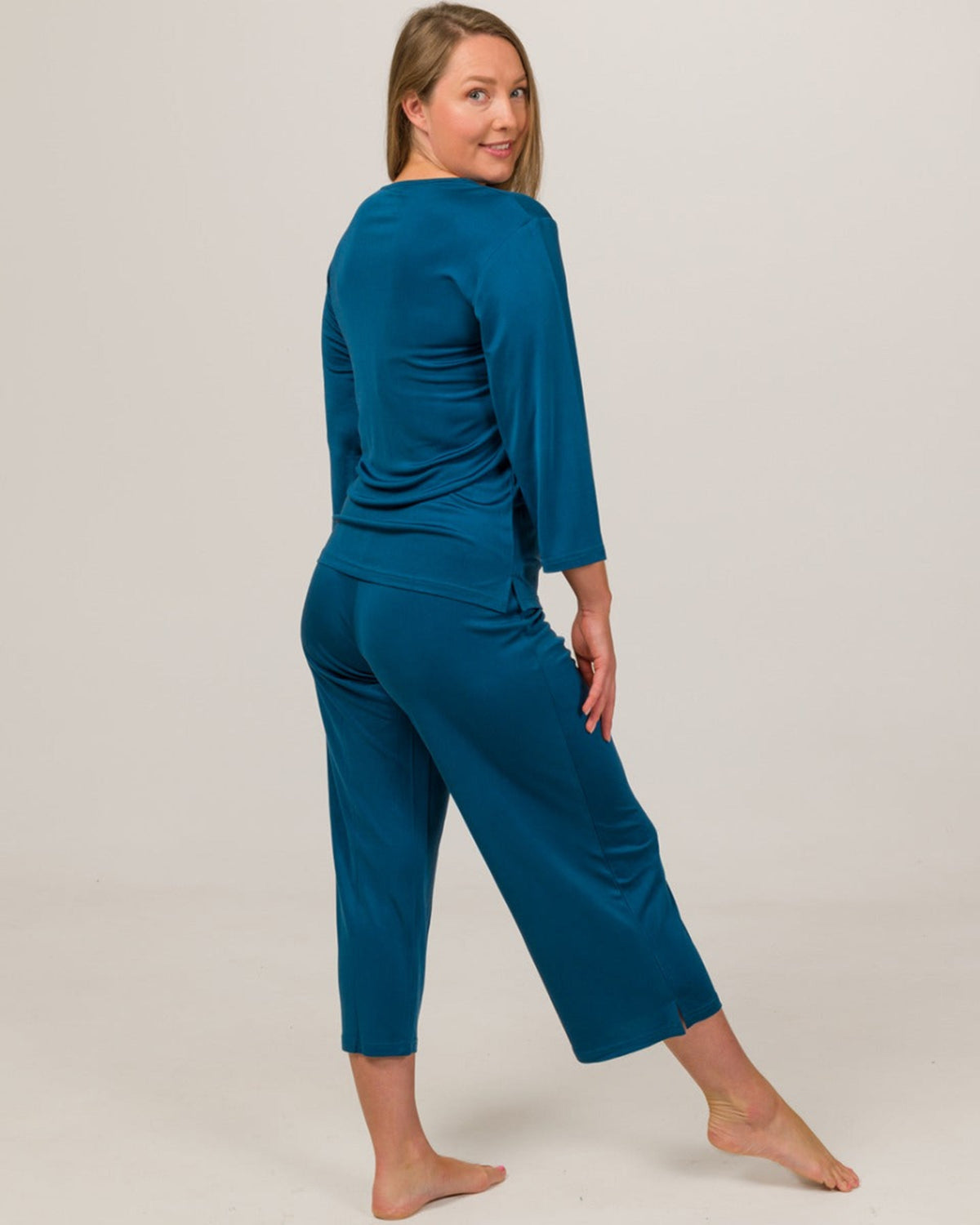 Woman wearing a silk peacock PJ set 
