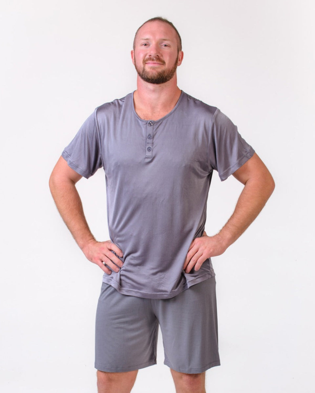 Man wearing a silk  gray Henley shirt and shorts set