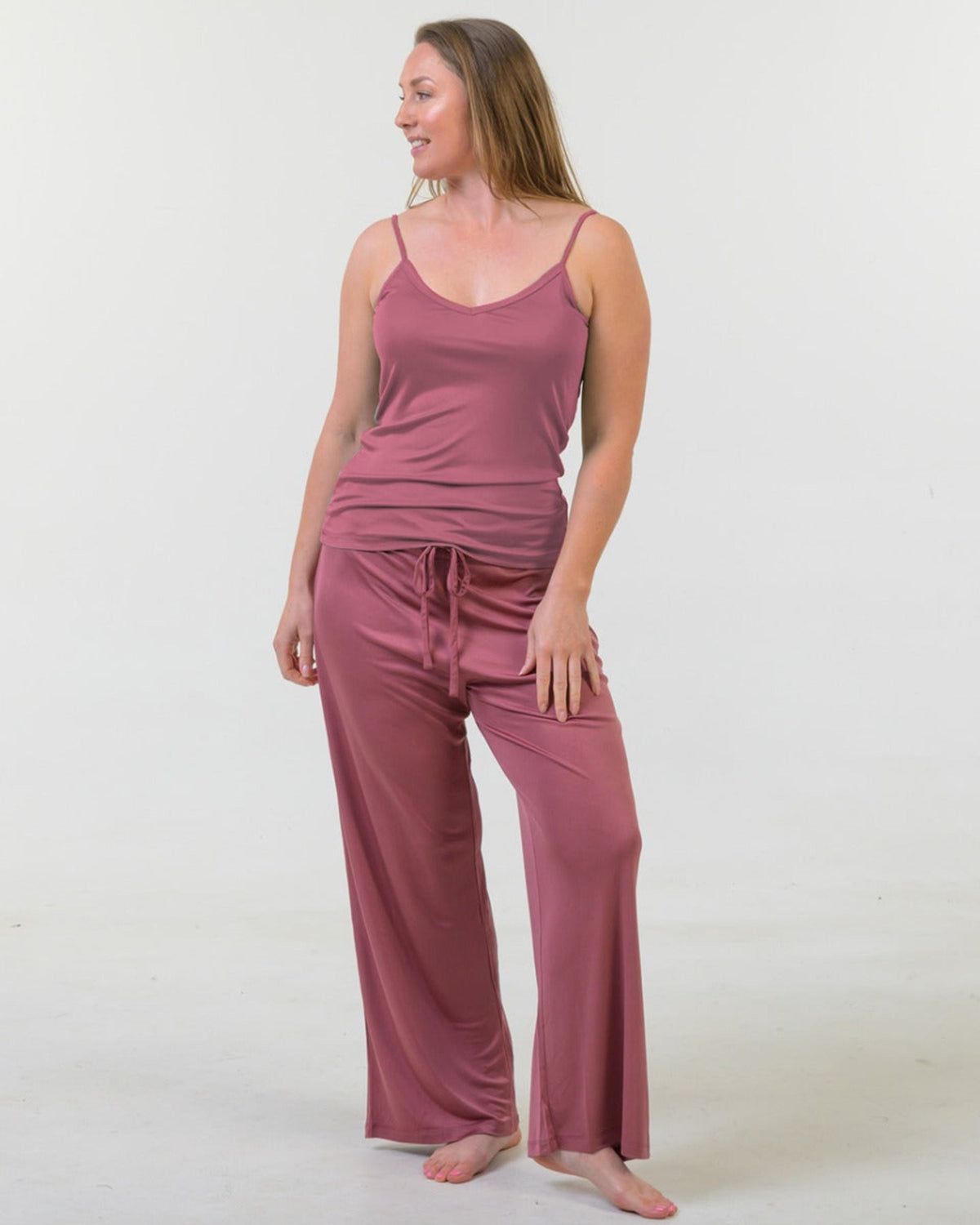 Woman wearing a Rose tank top and silk long pants pants set 
