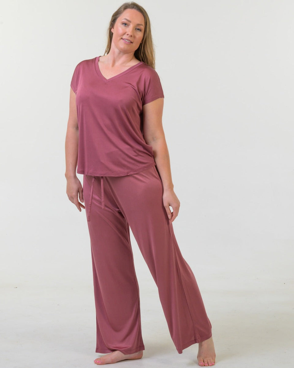 Woman wearing a rose  silk long pants pajama set