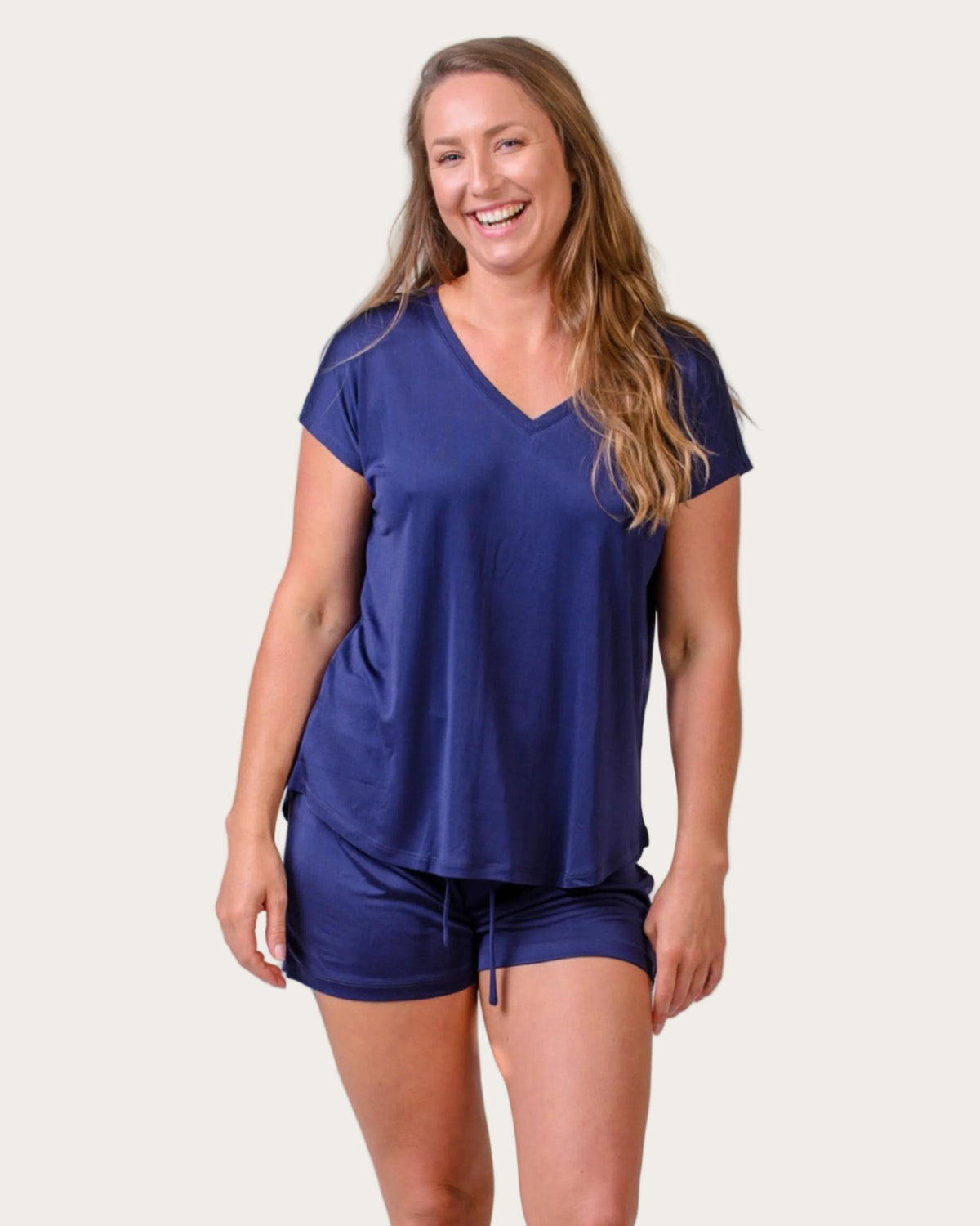Woman wearing a silk blue short sleeve vee neck top lounge wear