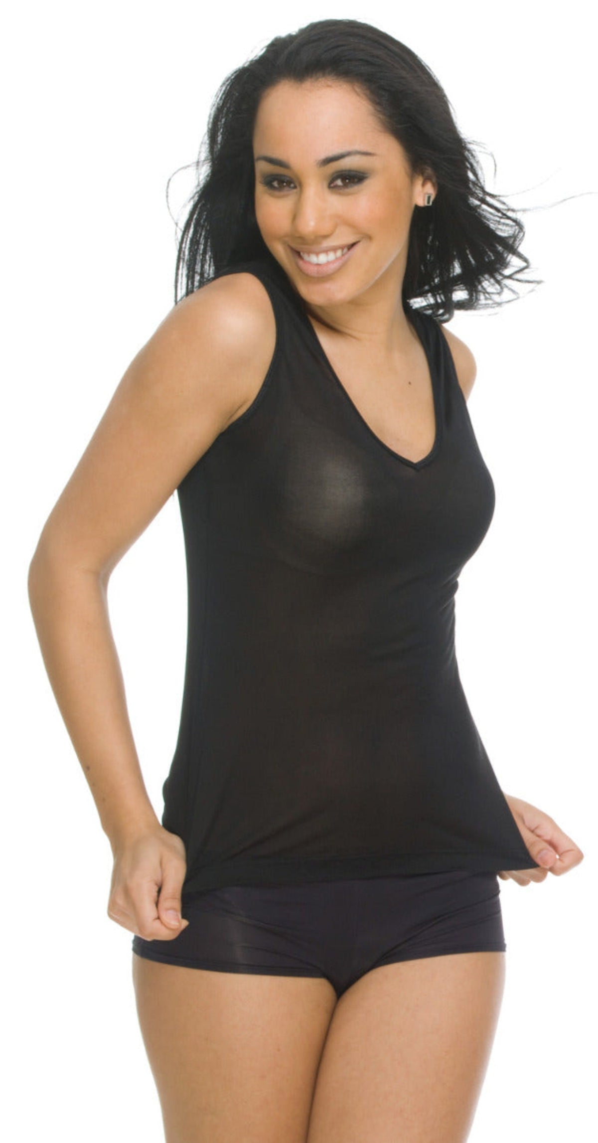 Woman wearing a silk  black tank top and shorts on a white background