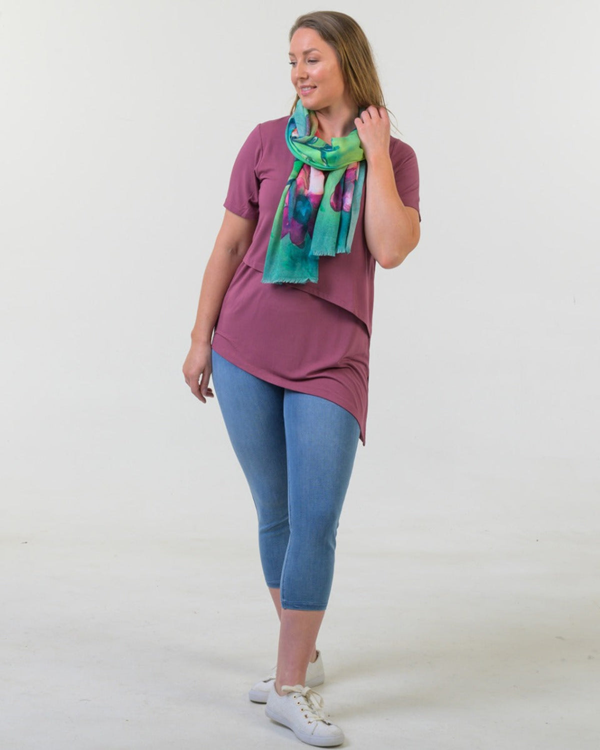 Woman wearing a crushed berry asymmetric longline tee shirt