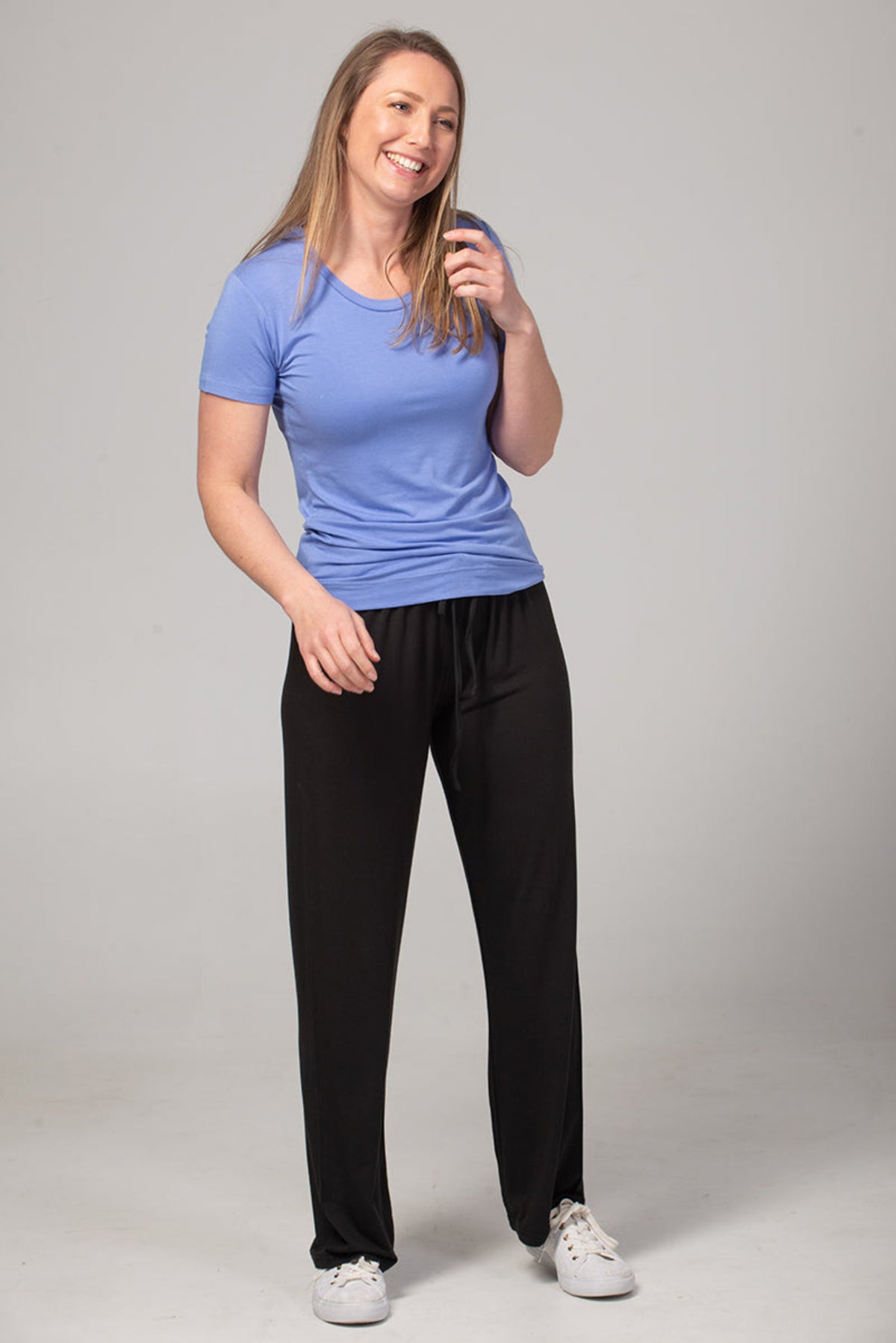 Bamboo leisure Woman wearing a blue top and black pants on a gray background
