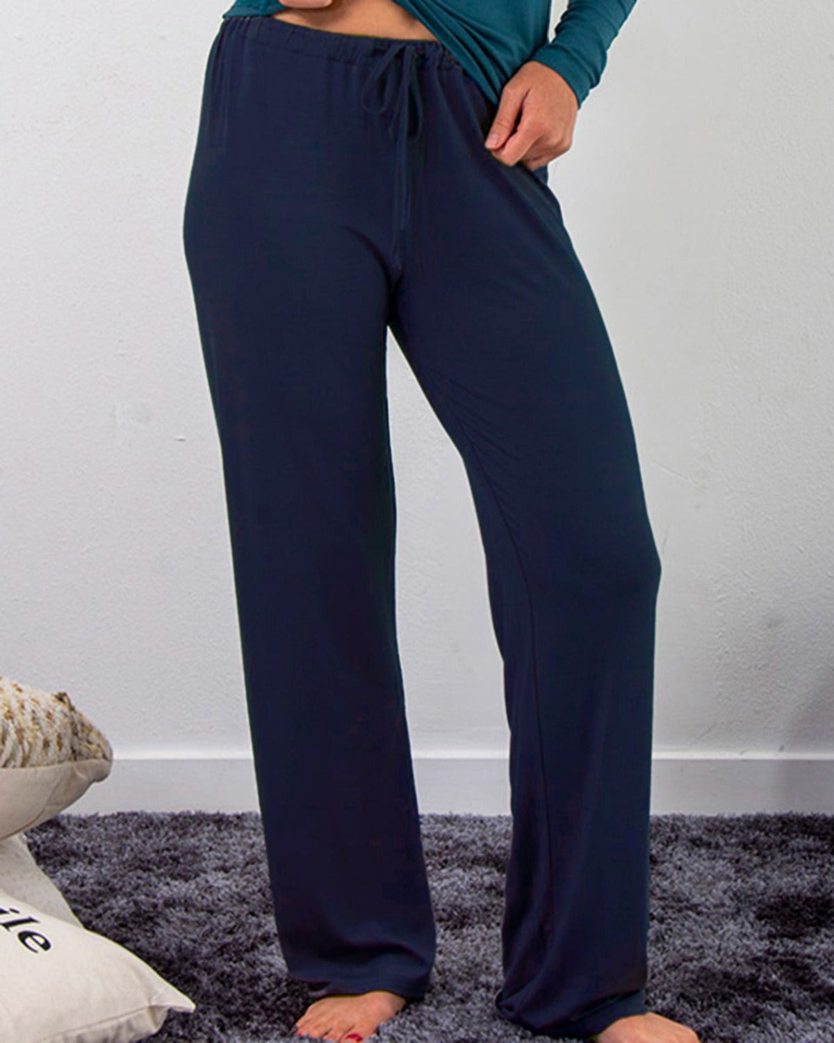 Bamboo leisure Person wearing navy blue lounge pants against a white wall.