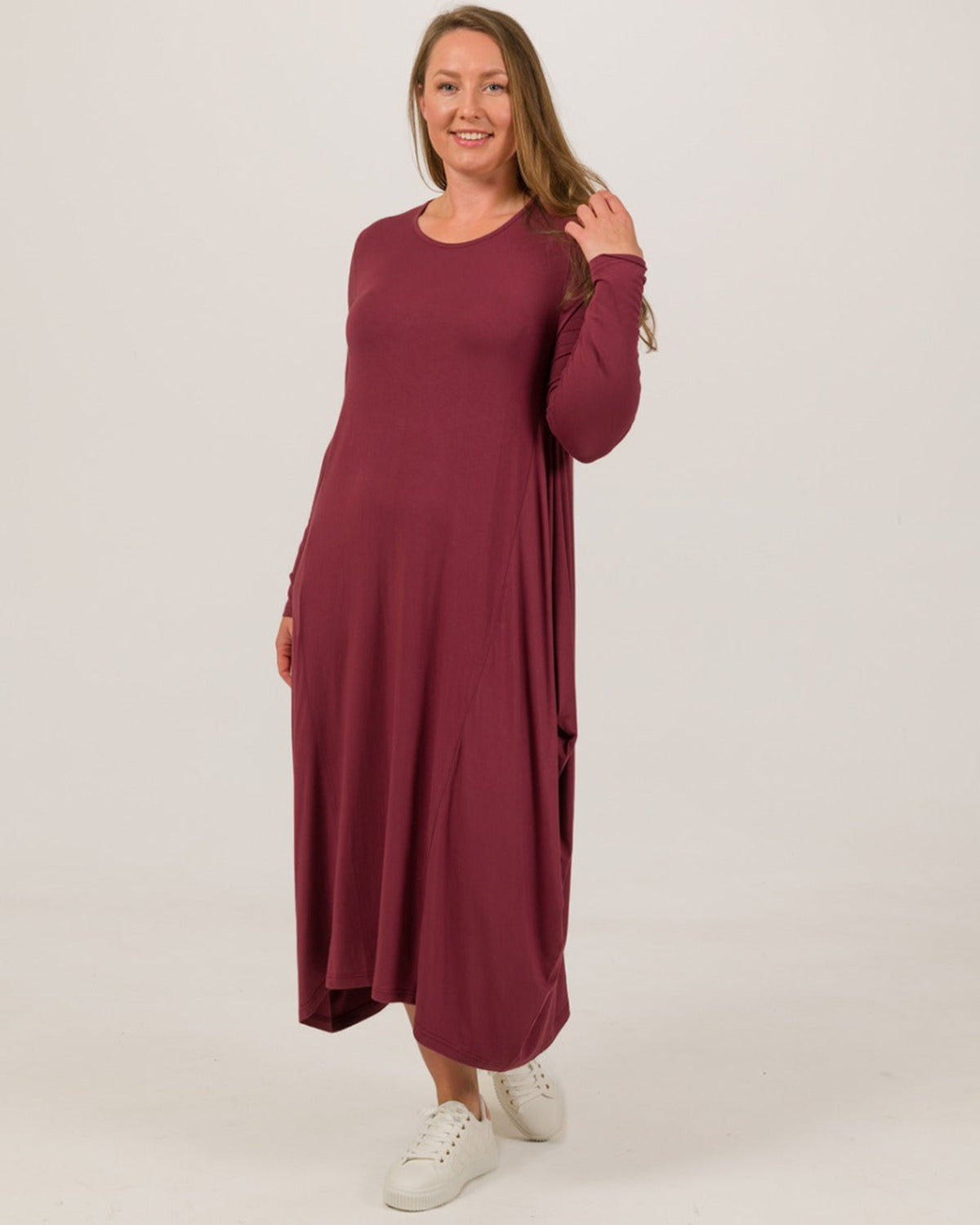 Woman wearing a burgundy dress on a white background