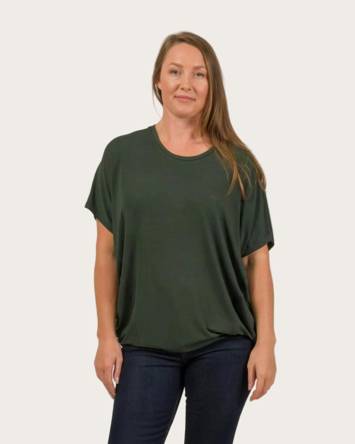 Woman wearing a green t-shirt against a plain background