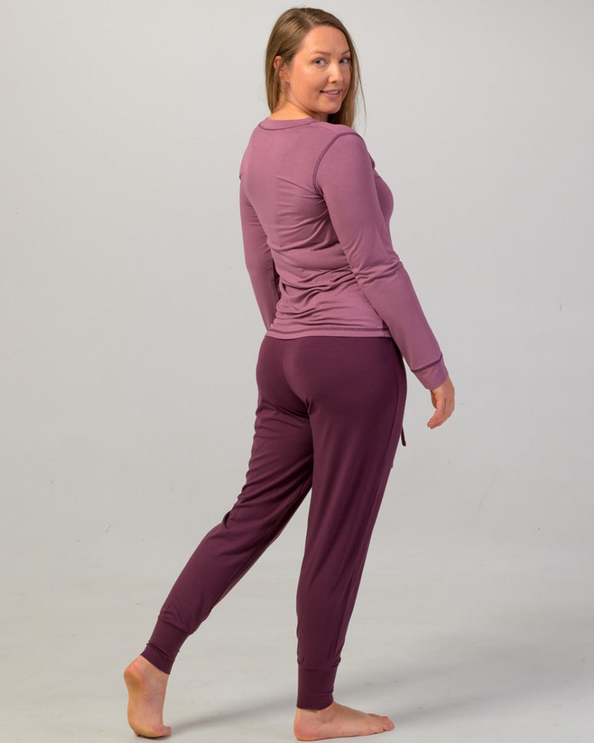 Woman wearing a eggplant pajama cuffed pants