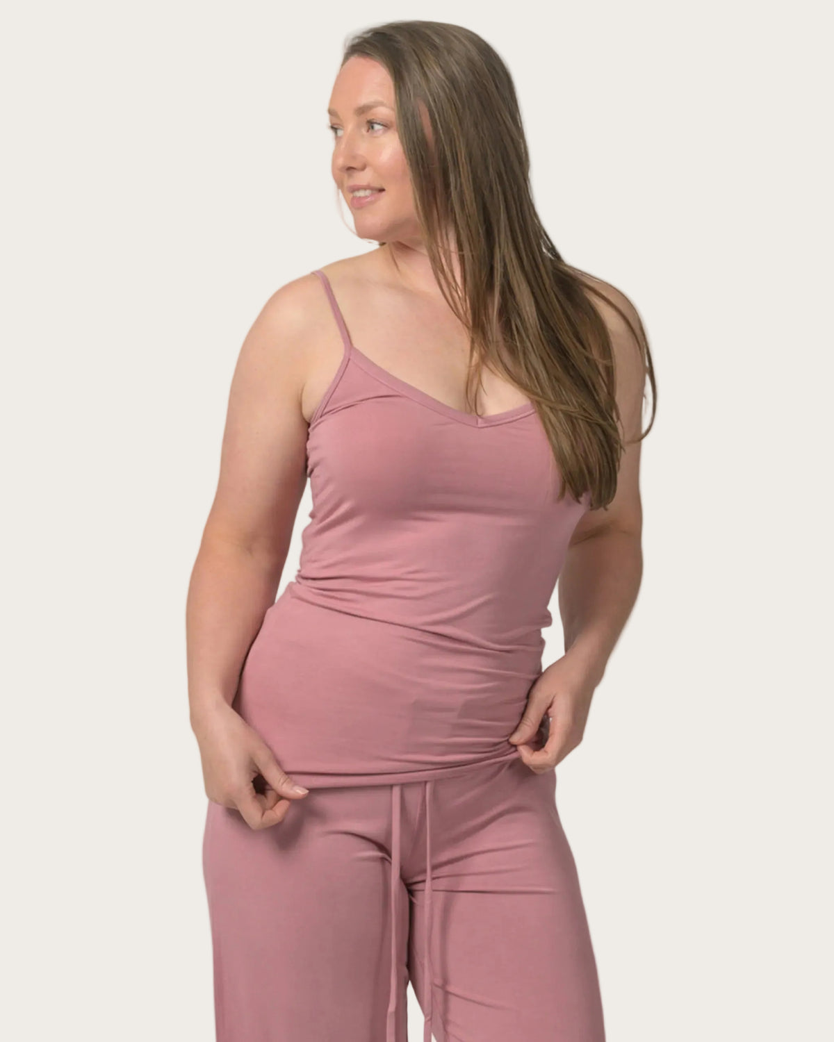 Woman wearing a bamboo pink matching set against a white background