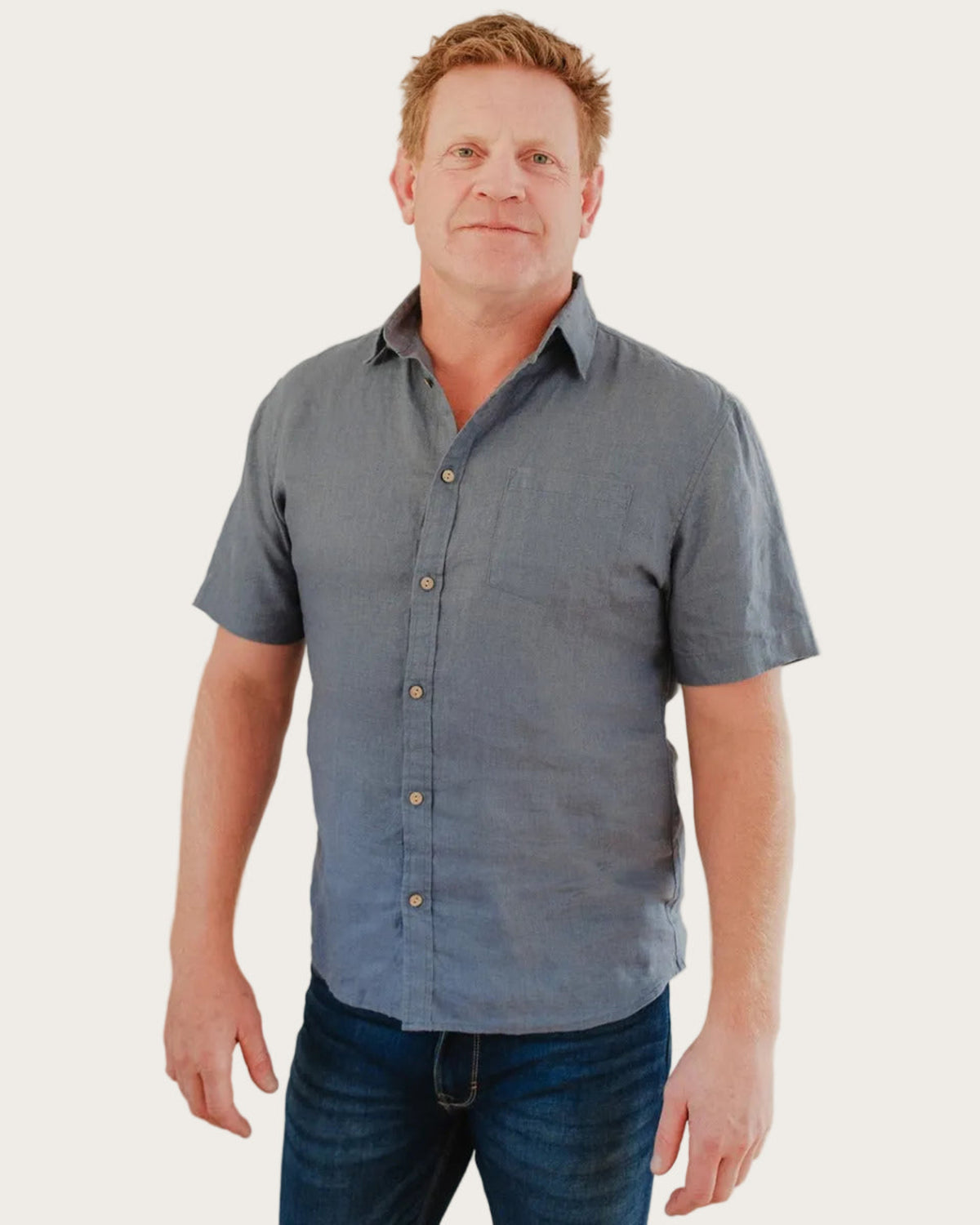 Man wearing a blue short-sleeve hemp shirt against a plain background
