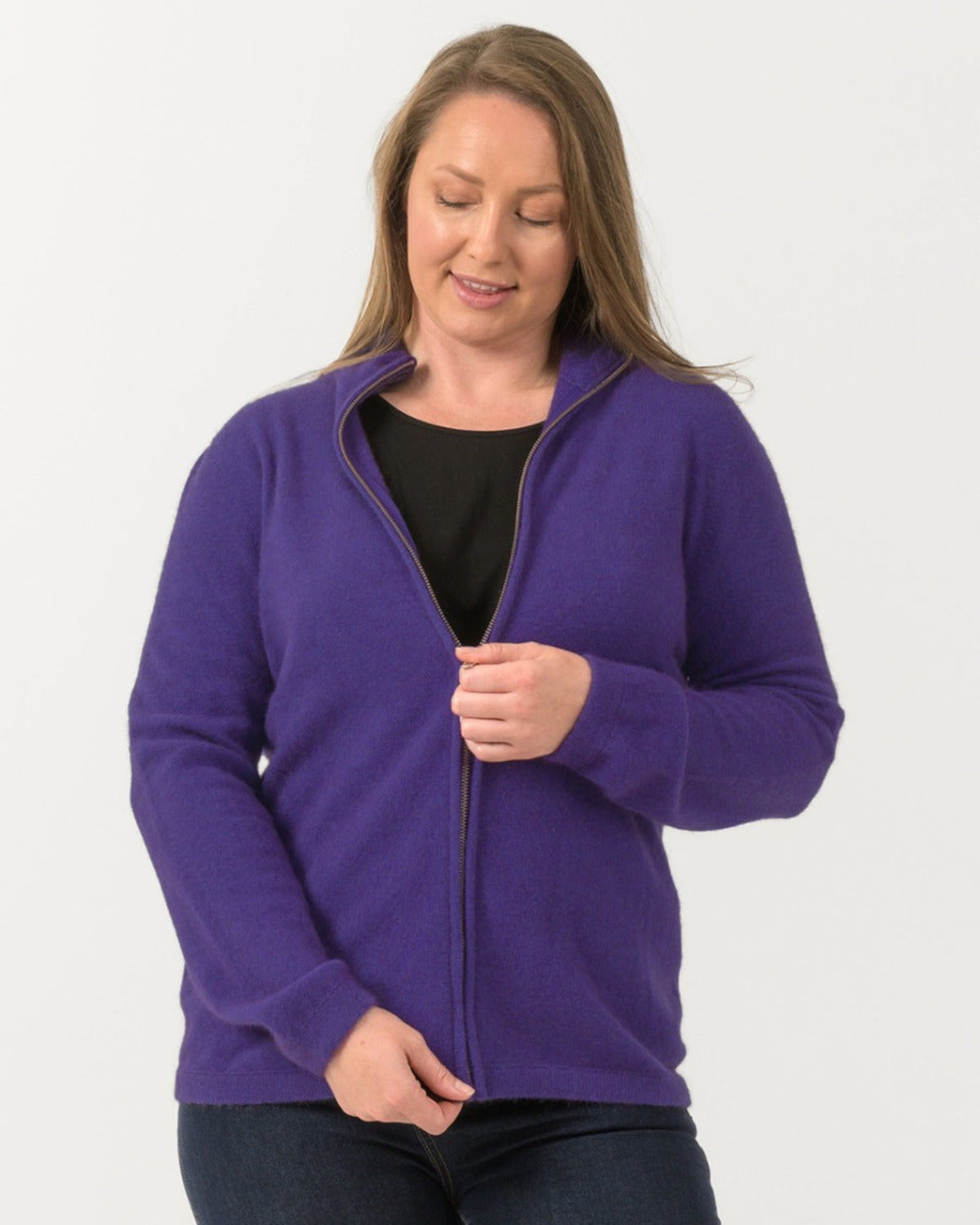 Woman wearing a possum merino purple fleece jacket on a white background