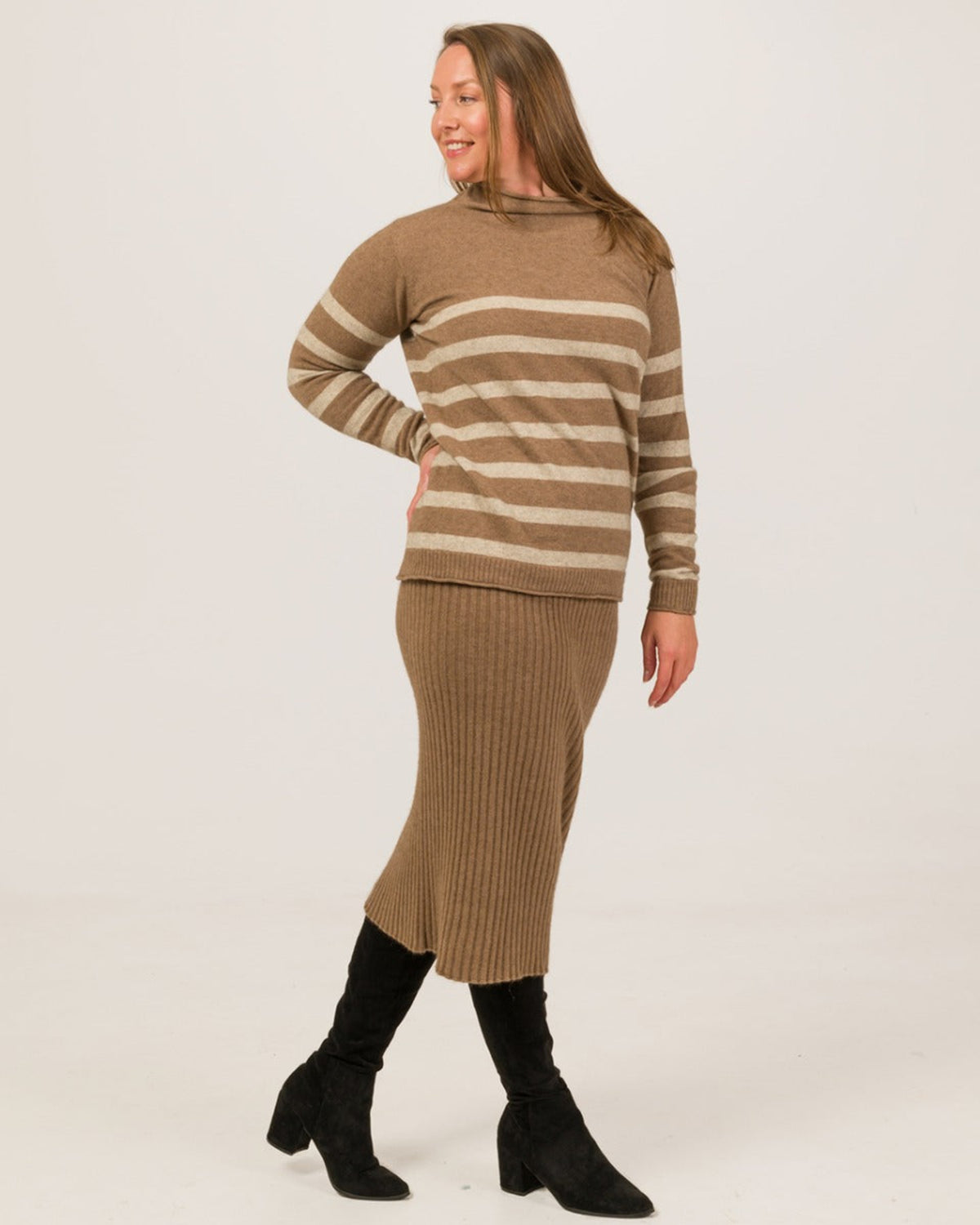 possum merino Woman wearing a brown and beige striped sweater and skirt set on a white background