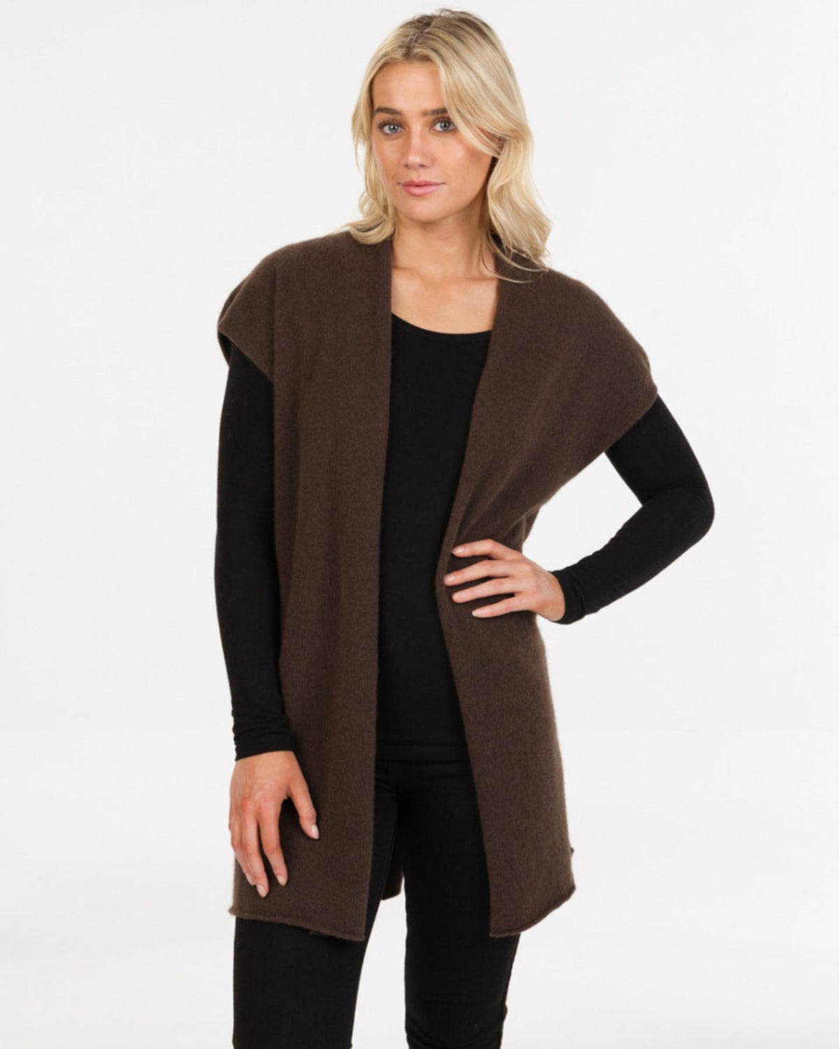 Possum merino gilet Woman wearing a brown cardigan over a black top on a white background
