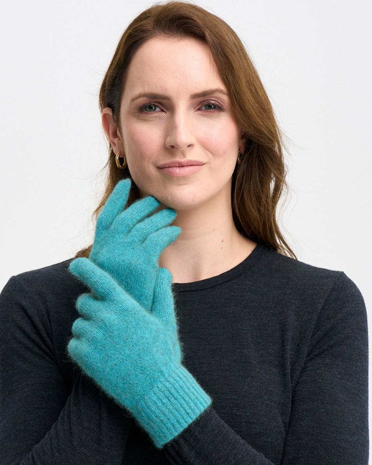 Possum merinio Woman wearing teal gloves against a white background