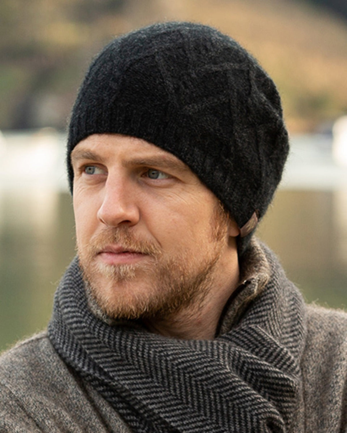 possum merino Man wearing a black knit beanie and gray scarf outdoors