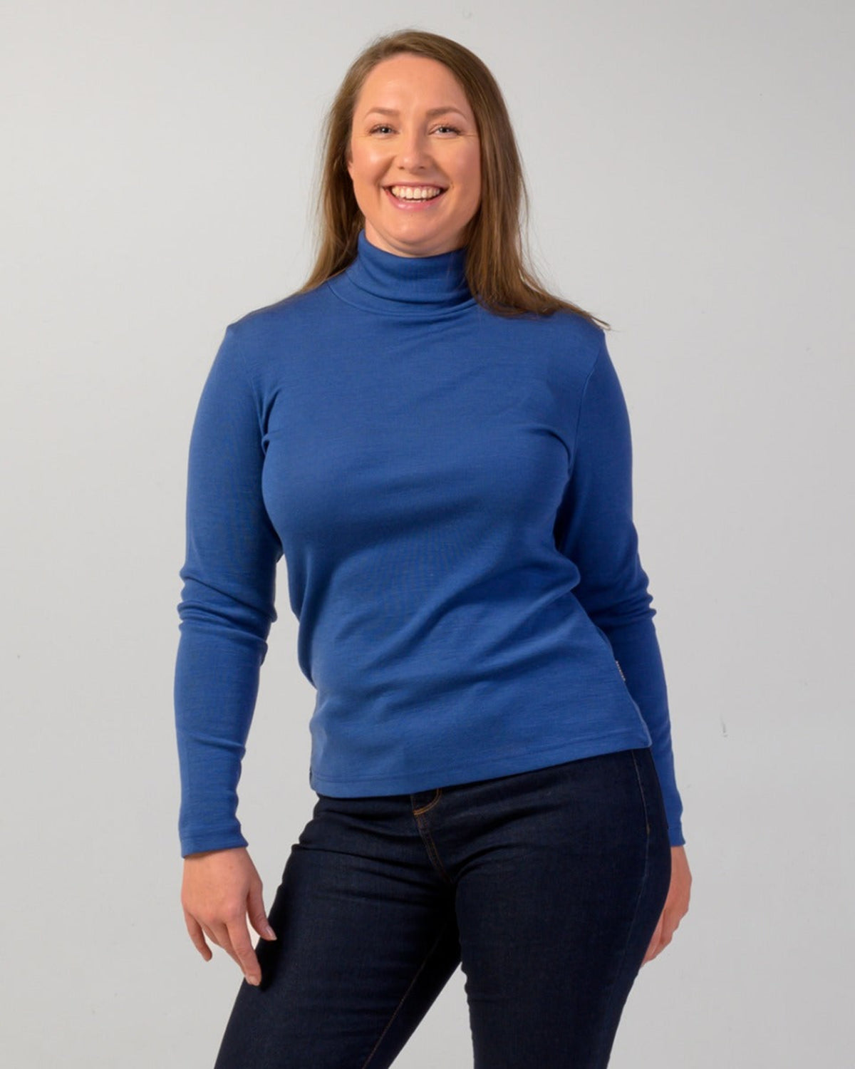 Woman wearing a merino roll neck  turtleneck sweater 