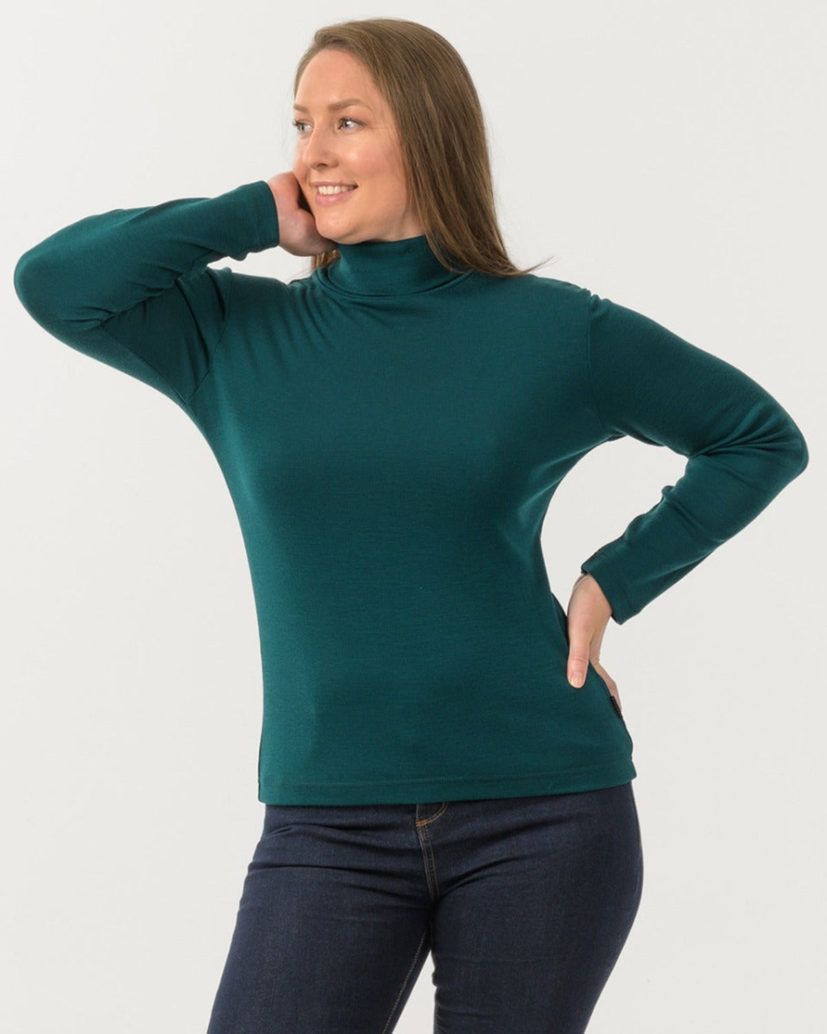 Woman wearing a teal turtleneck sweater on a white background