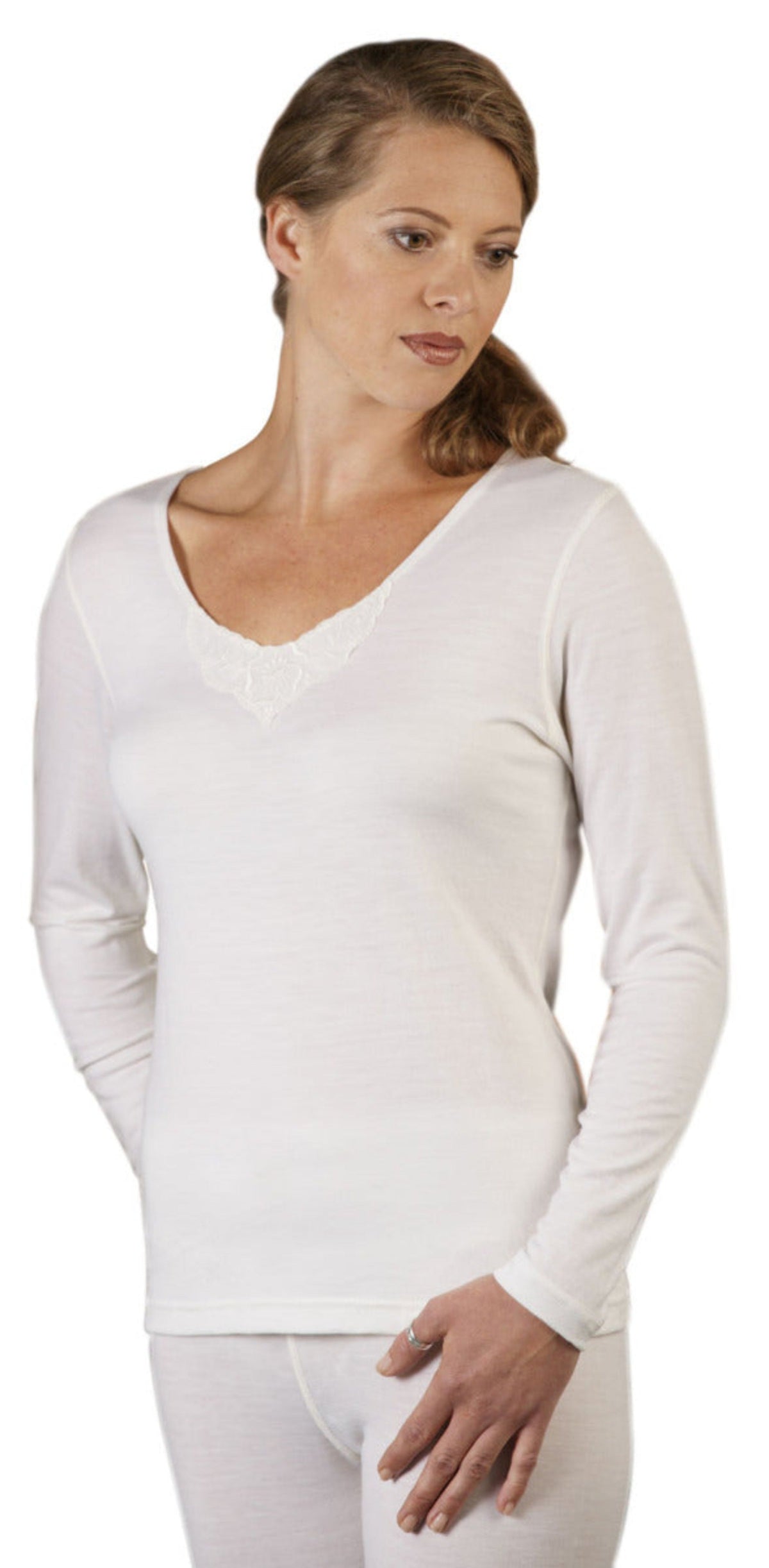 Woman wearing a merino white long-sleeve top on a white background