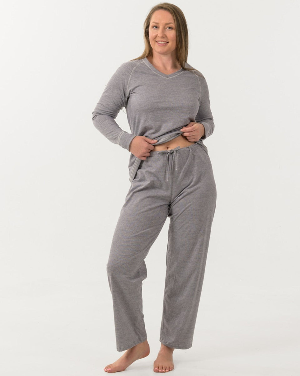 Woman wearing merino cotton gray pajama set on a white background