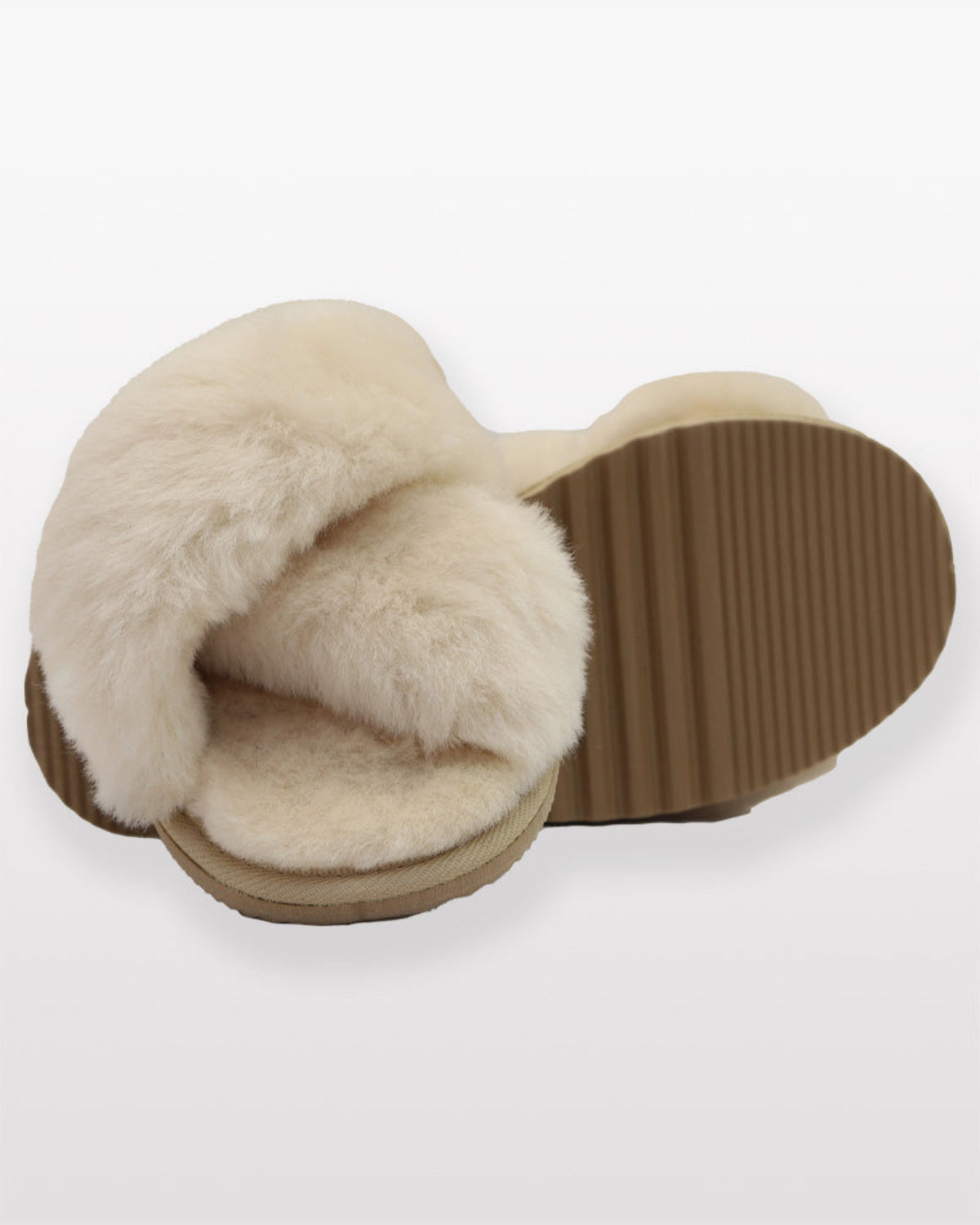 sheepskin crossover Beige fluffy slippers on a white background