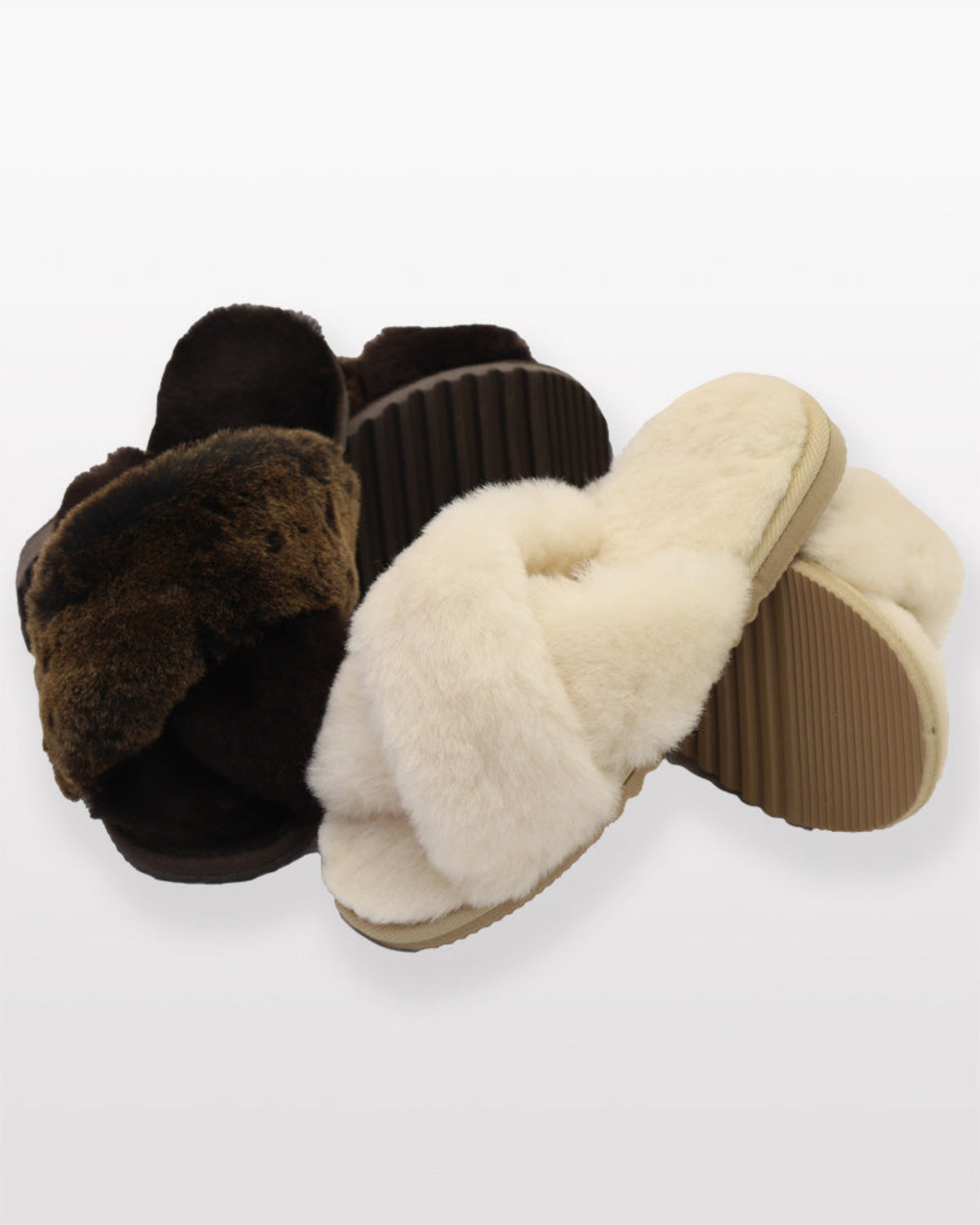 sheepskin crossover slippers Pair of brown and beige slippers on a white background