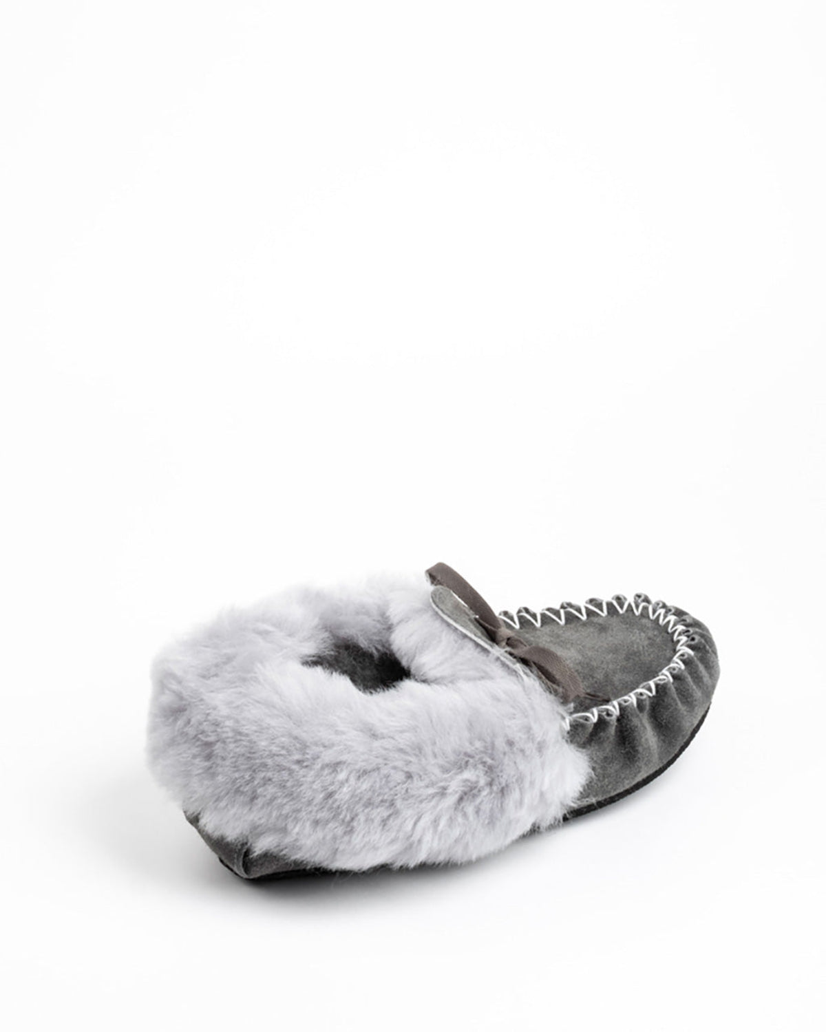 A single gray suede sheepskin moccasin slipper with a fluffy light gray faux fur cuff and a small gray bow, shown on a plain white background.