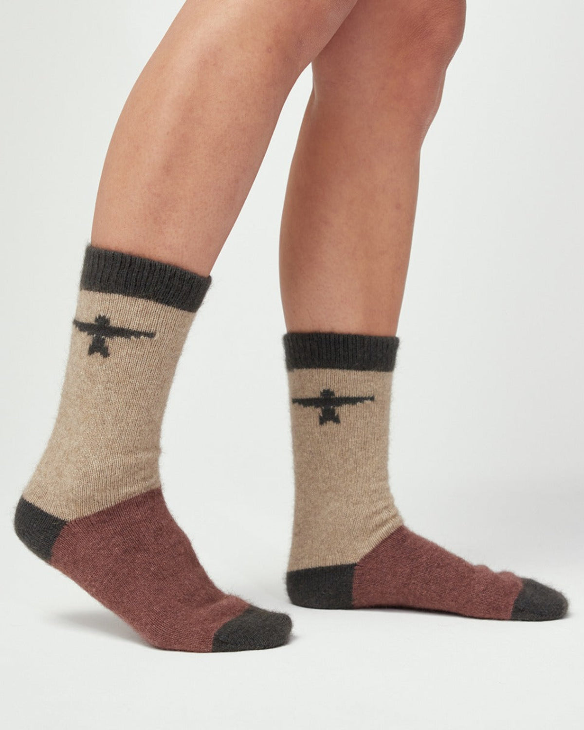 Possum Merino Beige and brown socks with black accents on a white background
