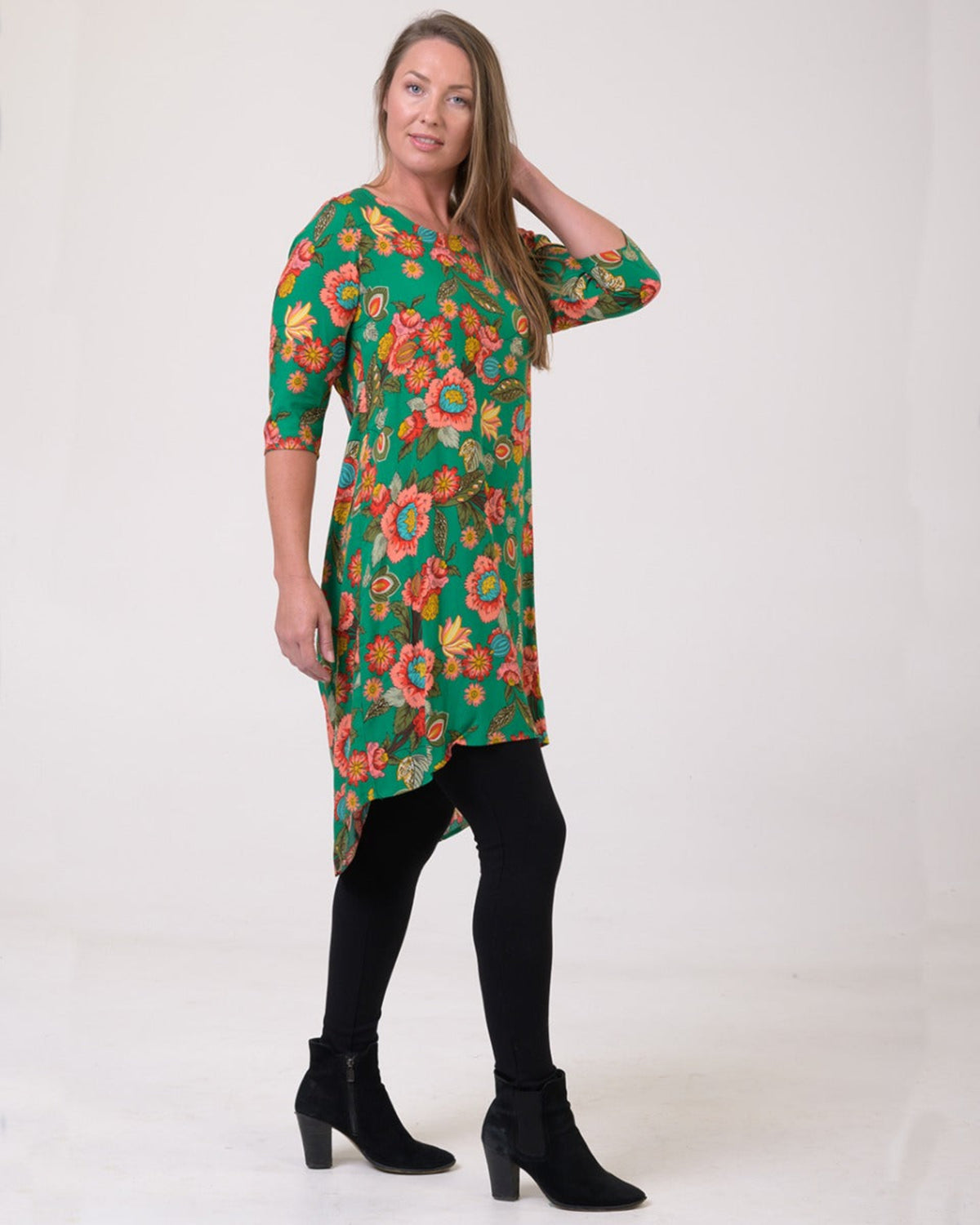 Woman wearing a green floral dress on a white background