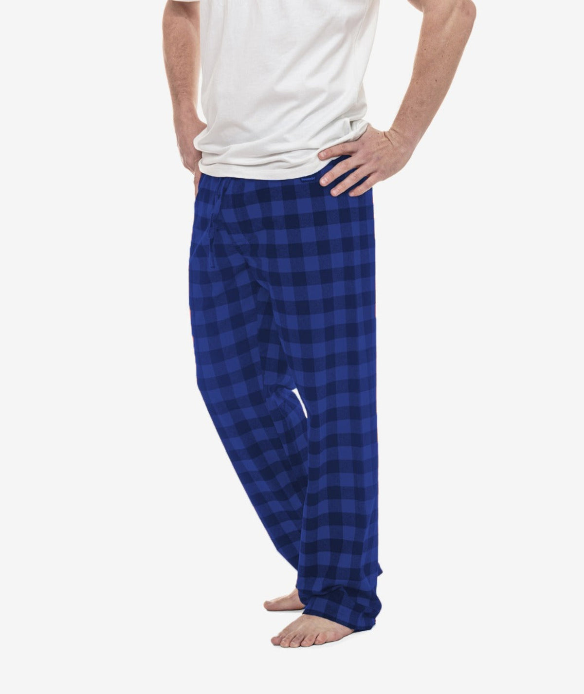 Person wearing blue checkered pajama pants on a white background