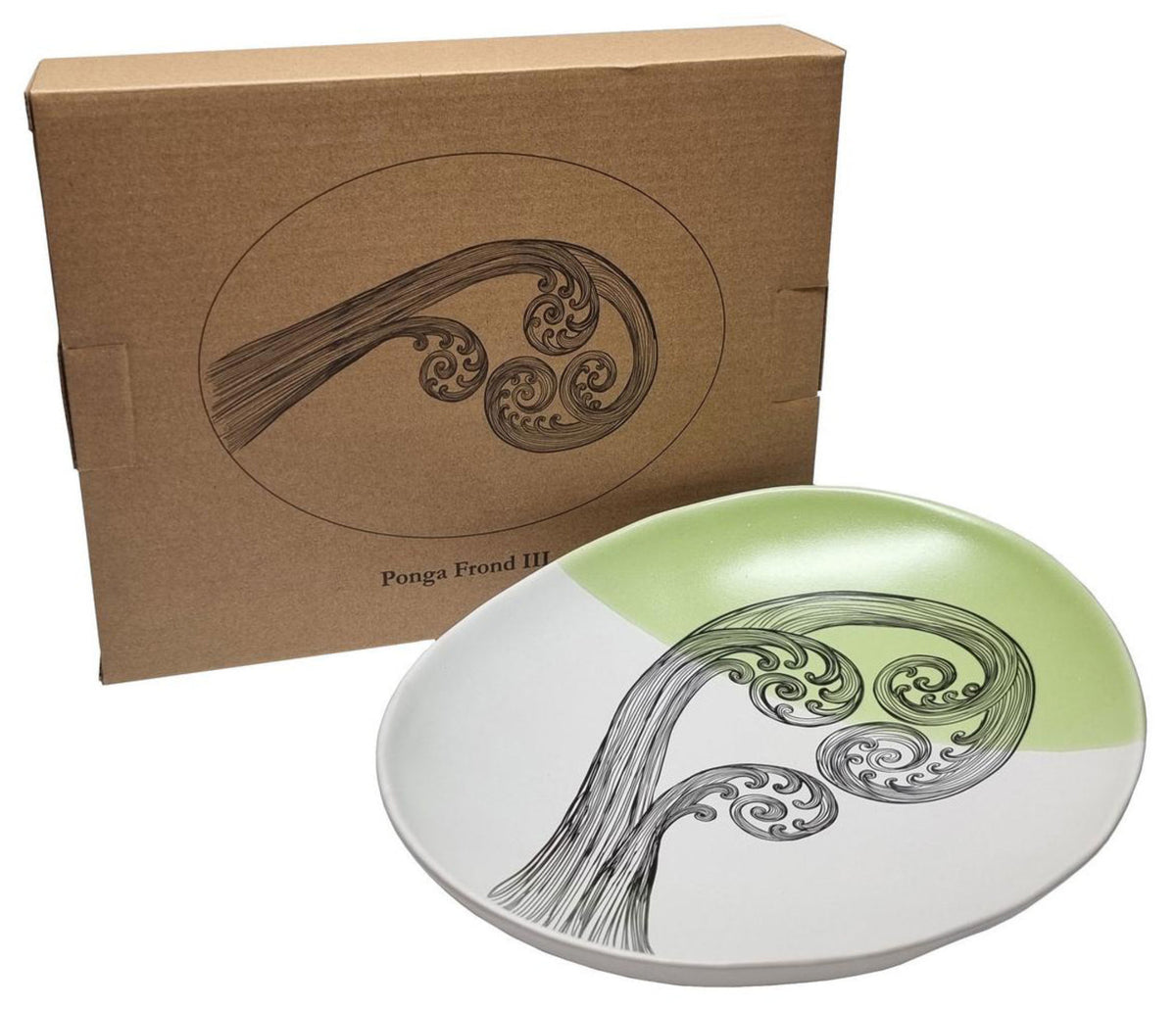 Decorative plate with artistic design and matching box on a white background