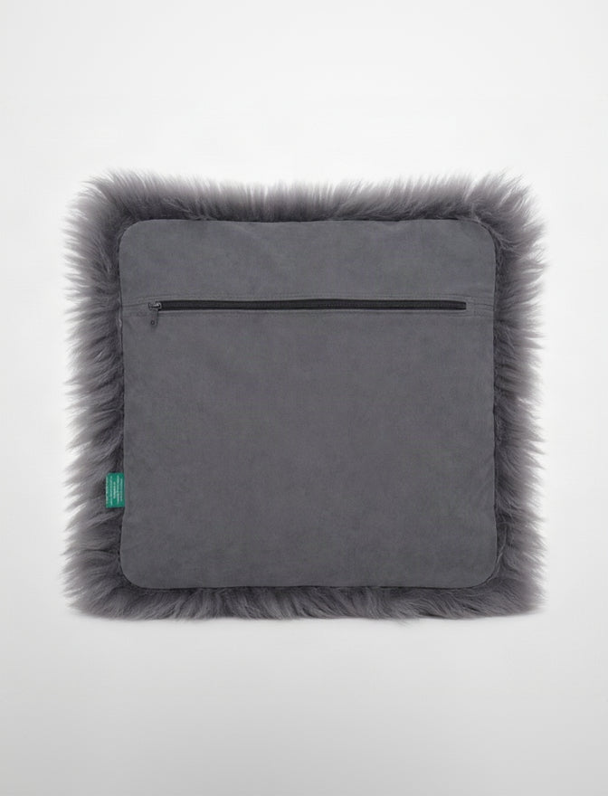 Gray pillow with fur trim on a white background