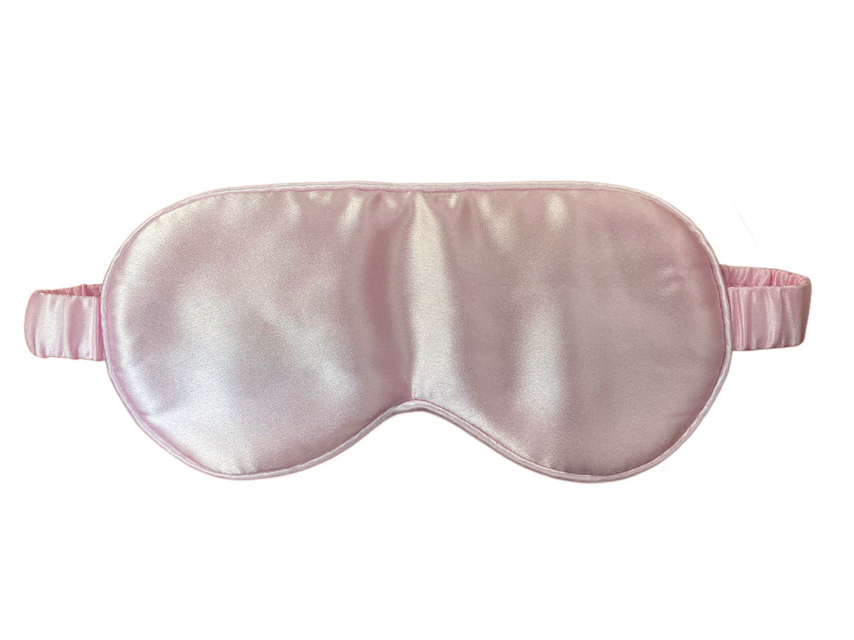 Pink silk satin eye mask on a white background