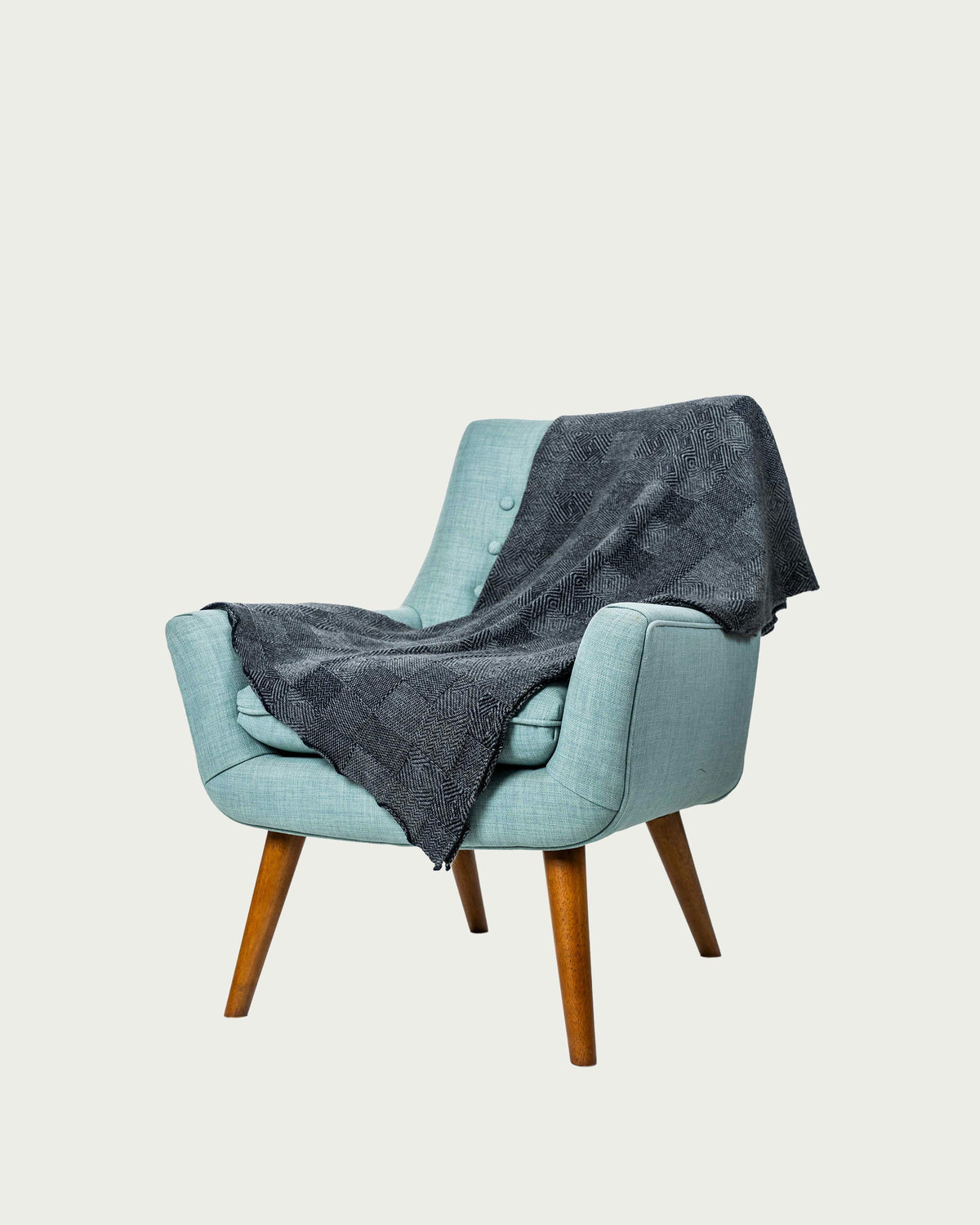Possum Merino throw in a navy and silver jacquard pattern
