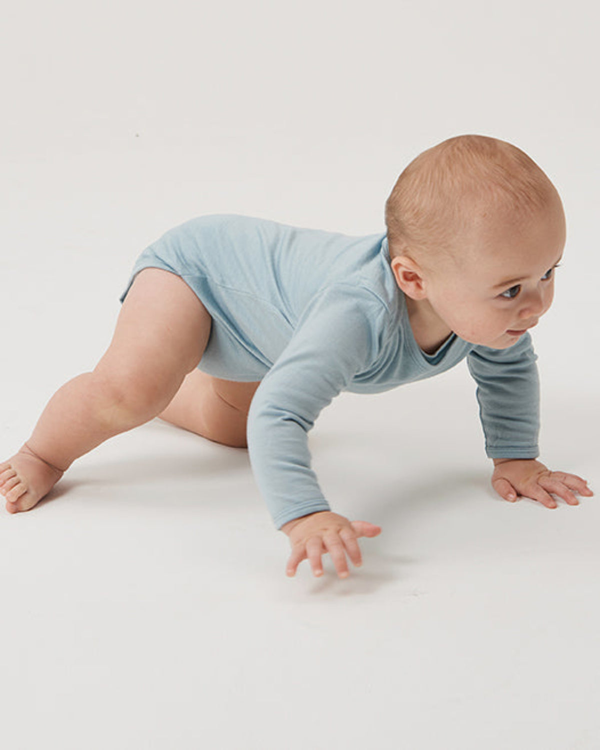 Baby in a light blue merino onesie 