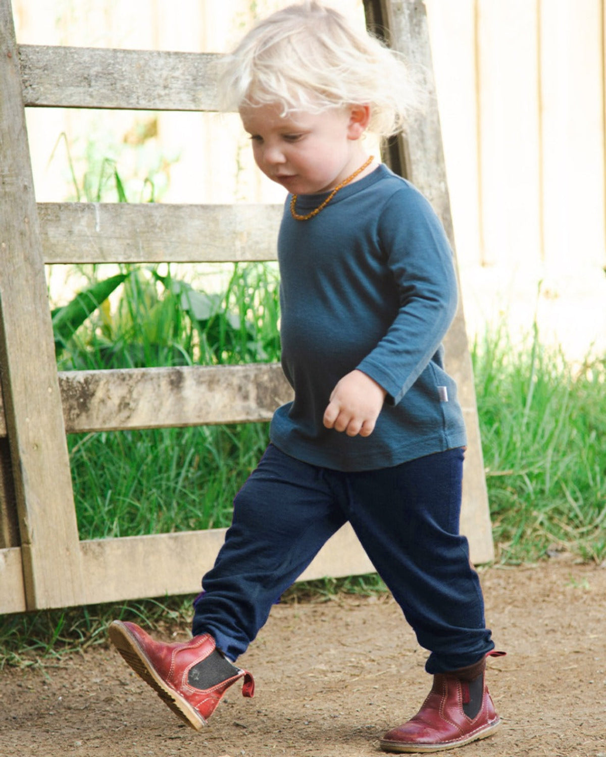 Child wearing a merino navy pants outdoors.