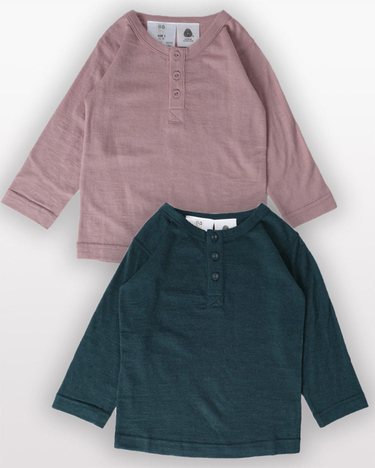 Merino Two long-sleeve shirts, one pink and one green, on a white background.