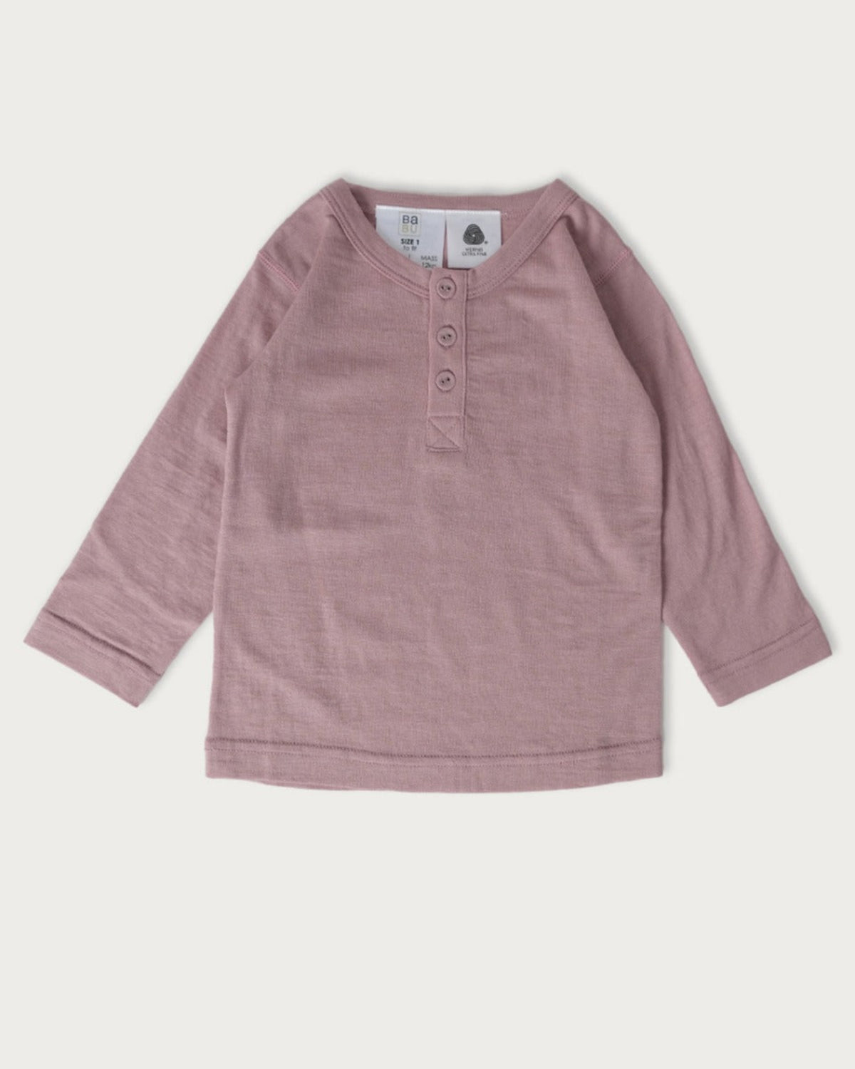 merino Pink long-sleeve shirt on a light gray background