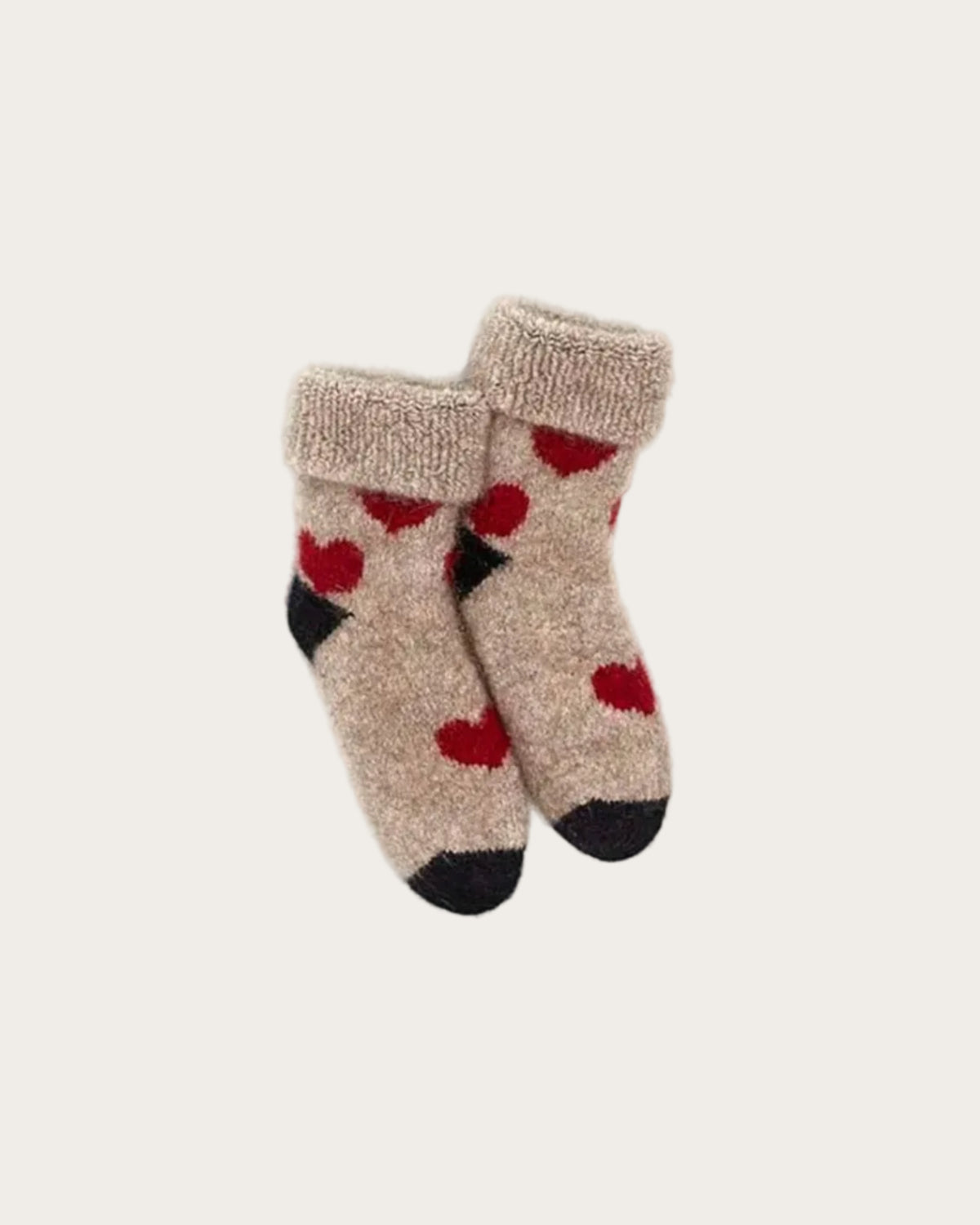 Beige Possum Merino baby socks with red heart patterns on a white background