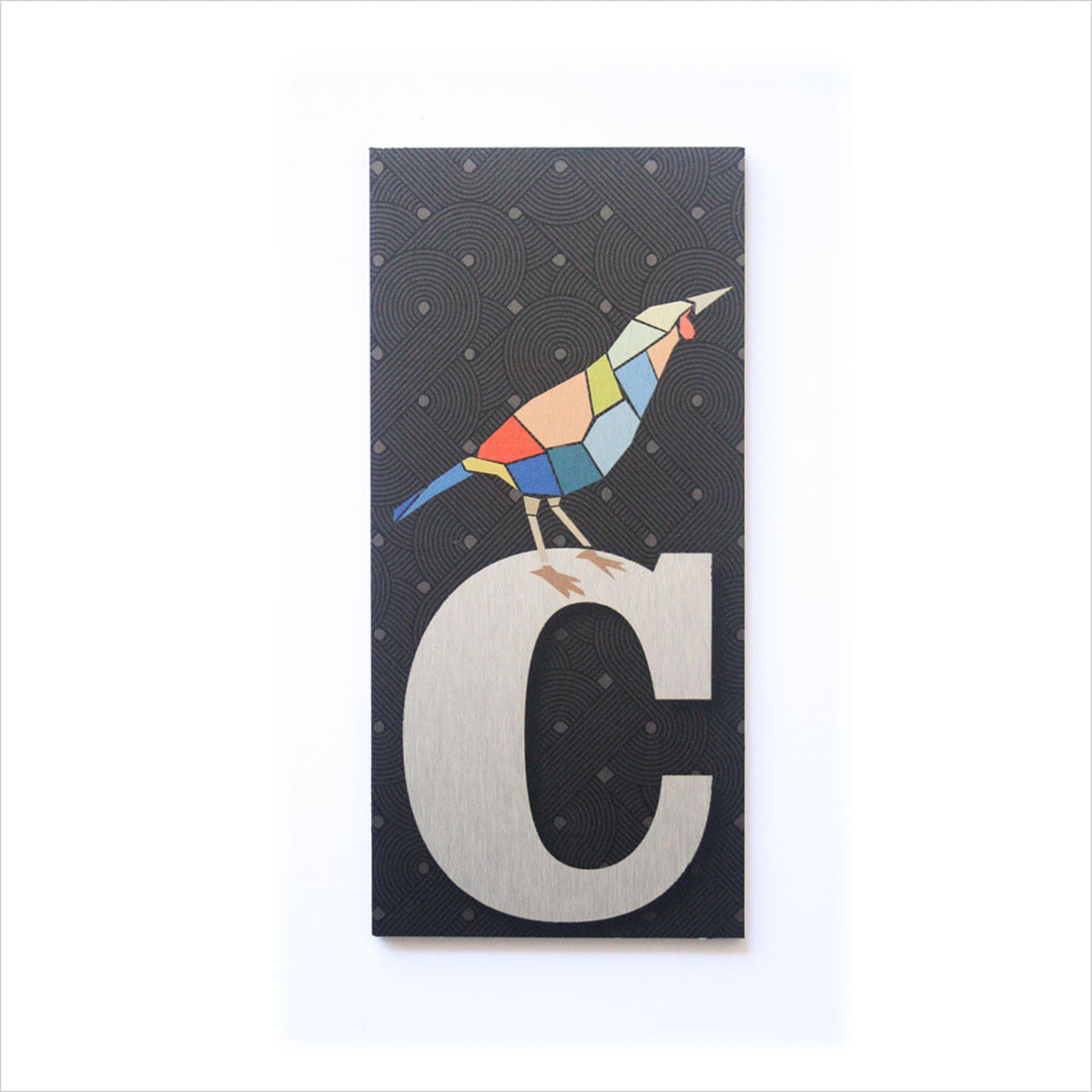 house  and letter box number  Colorful bird design on a black background with a large white letter 'C'.