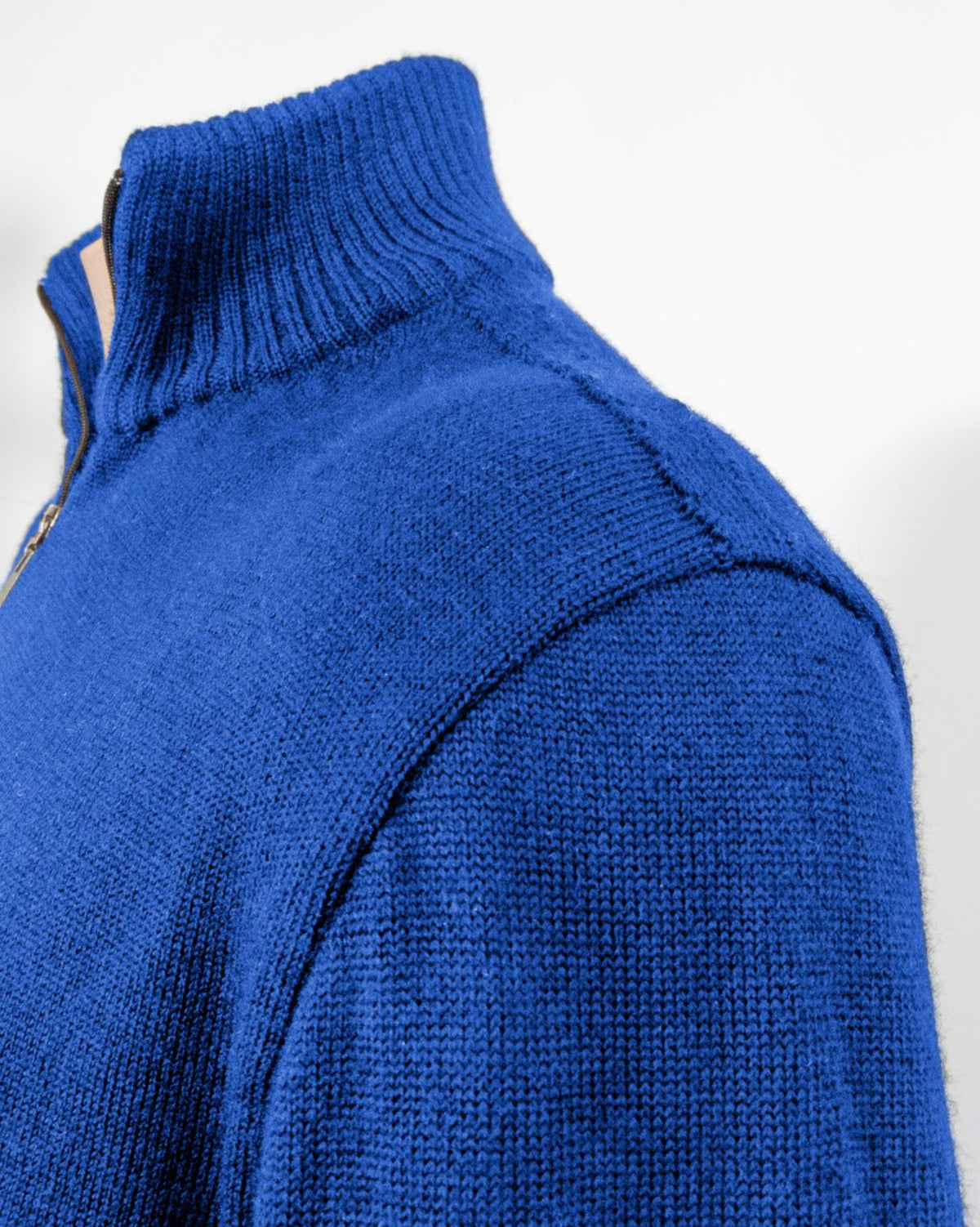 Close-up of a merino blue knitted sweater on a white background