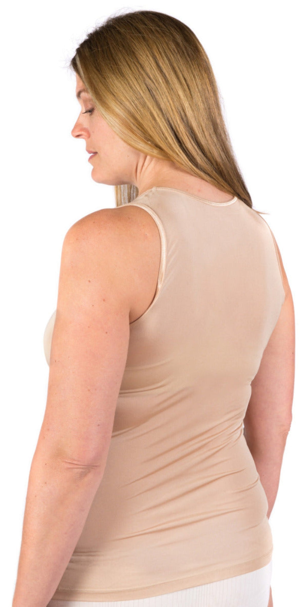 Woman wearing a silk latte singlet top on a white background
