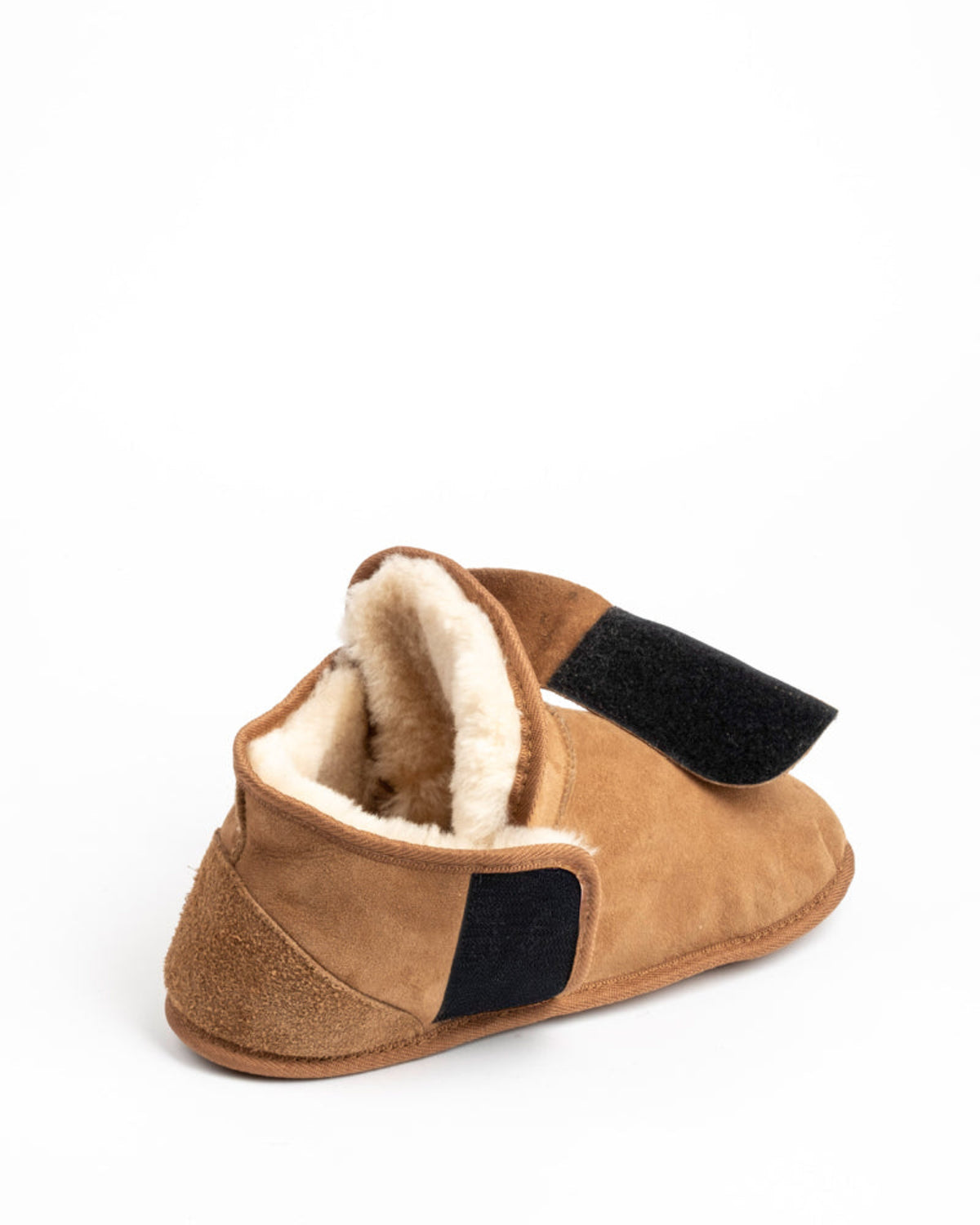 Brown  adjustable sheepskin slipper with black accents on a white background