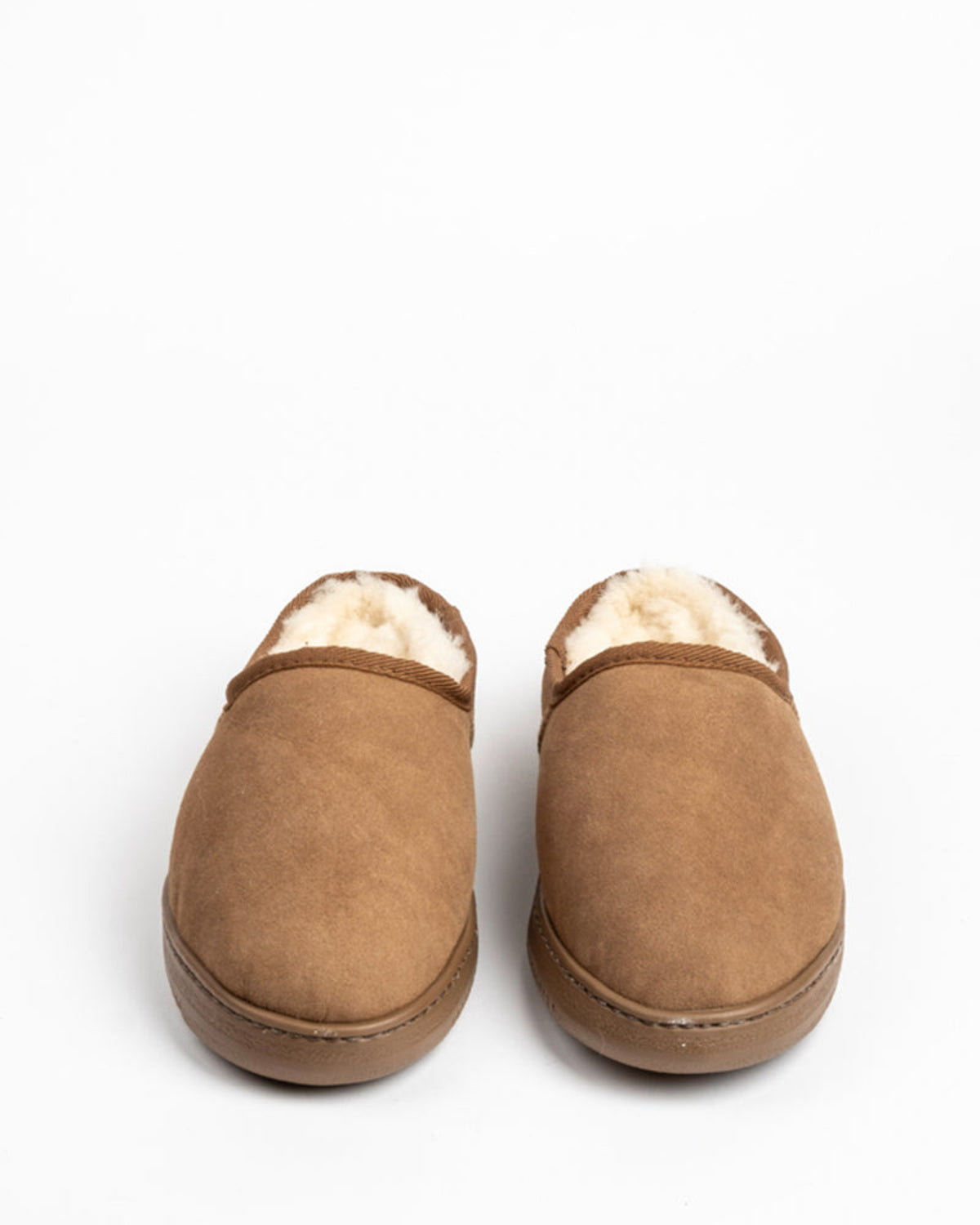 sheepskin .clogPair of brown slippers with white fur lining on a white background