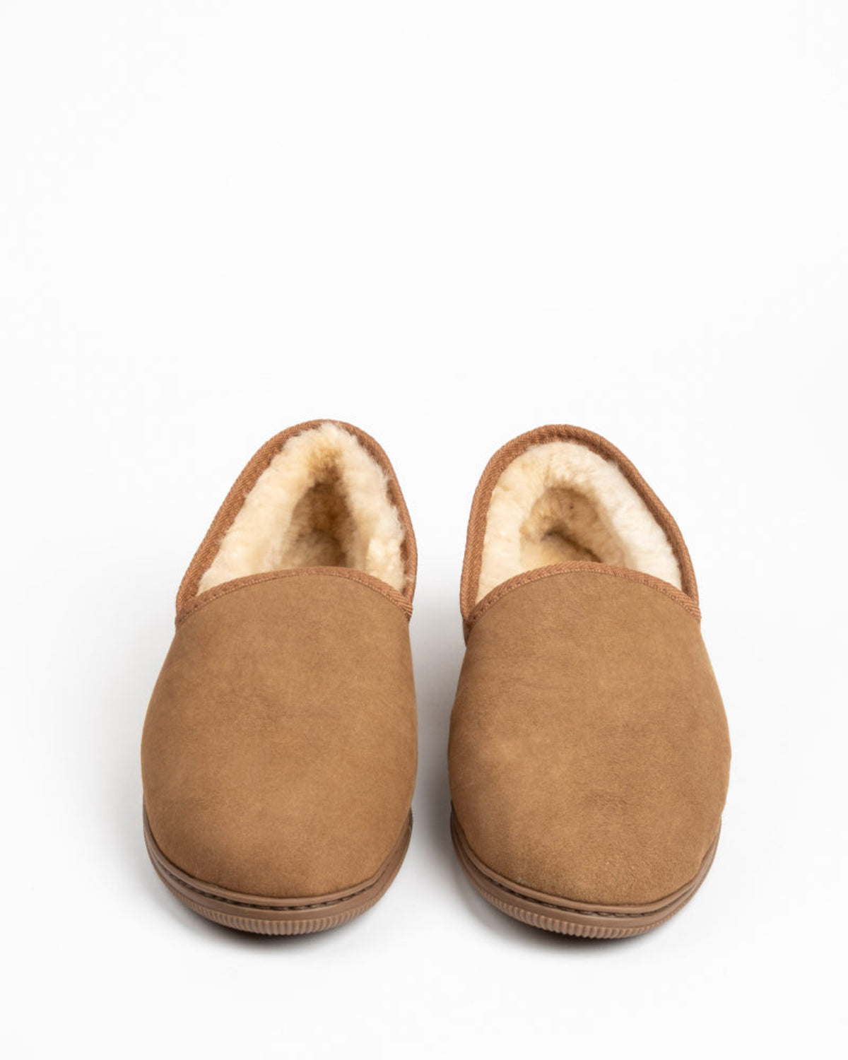 Pair of brown sheepskin slippers with fluffy interior on a white background