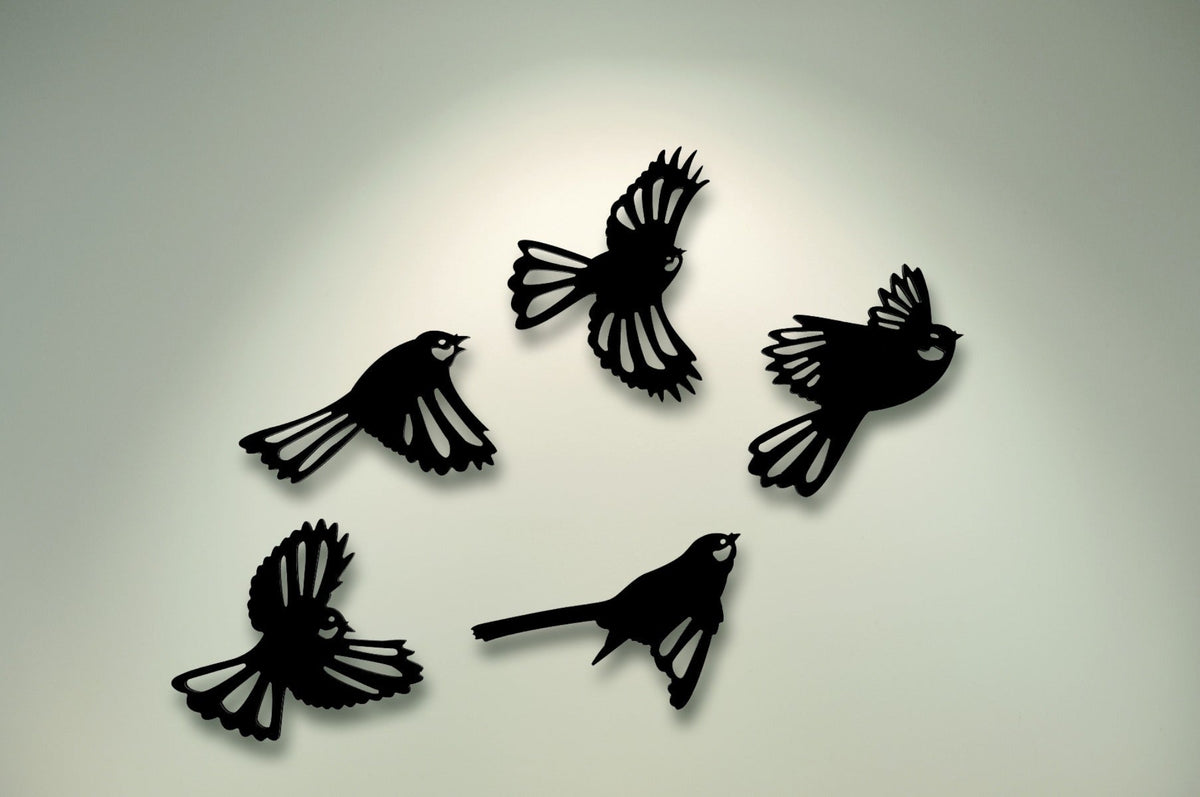 gBlack bird silhouettes on a light gray backgroundfantail 